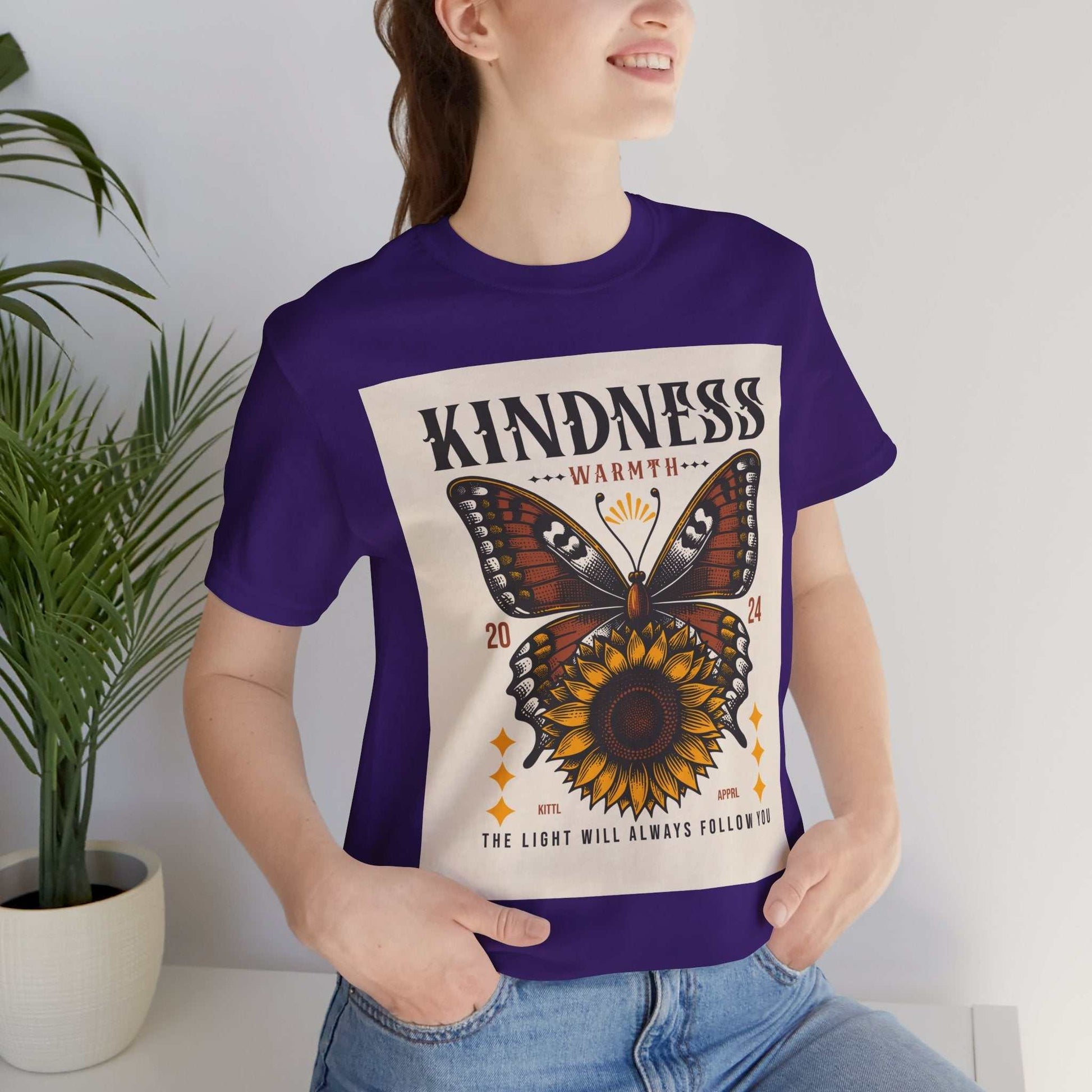 Woman wearing purple Kindness Butterfly Tee with butterfly and sunflower design and kindness message