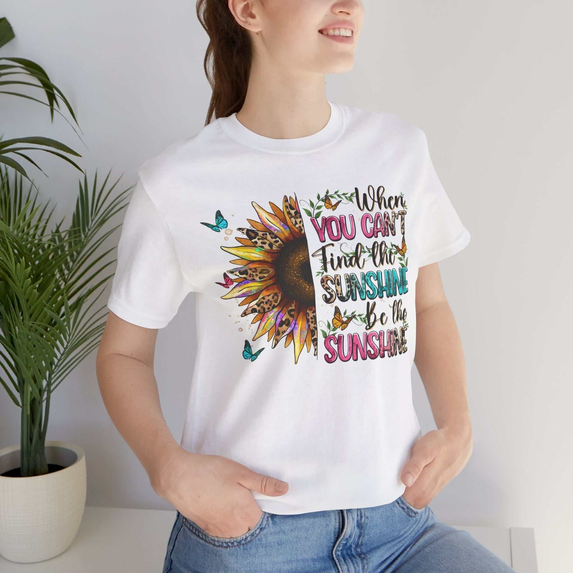woman wearing white Sunshine Quote Tee with sunflower and colorful positive message print