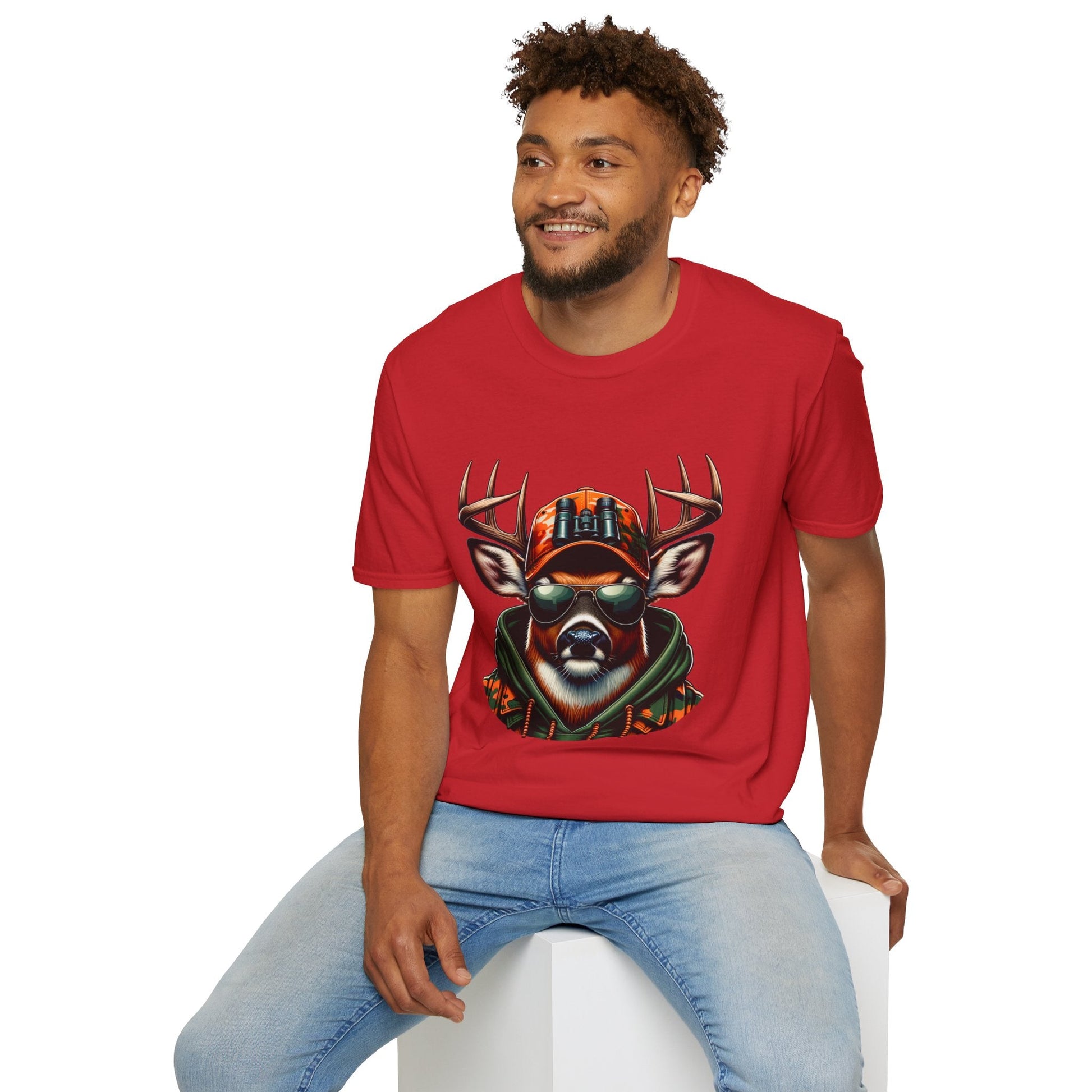 Man wearing red Hunting Enthusiast T-Shirt with cool deer graphic and sunglasses sitting on white block