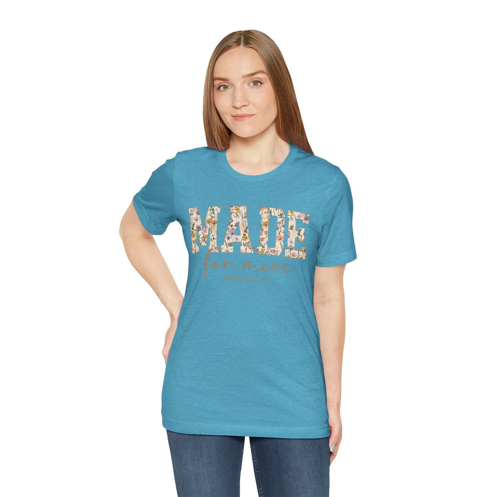 Woman wearing blue Made for More Tee with floral text design, casual fit and short sleeves.