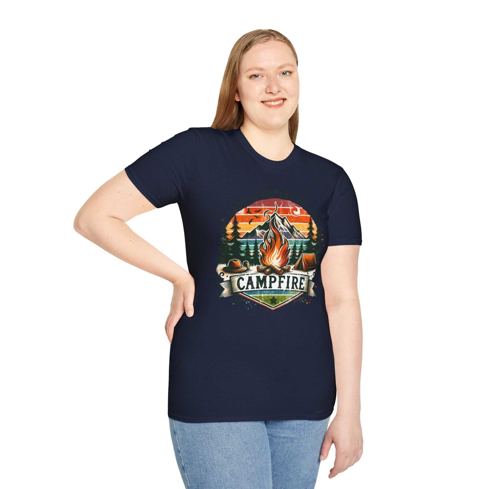 Woman wearing navy Camping Adventure Unisex T-Shirt with vibrant campfire graphic and "Campfire" text, paired with blue jeans