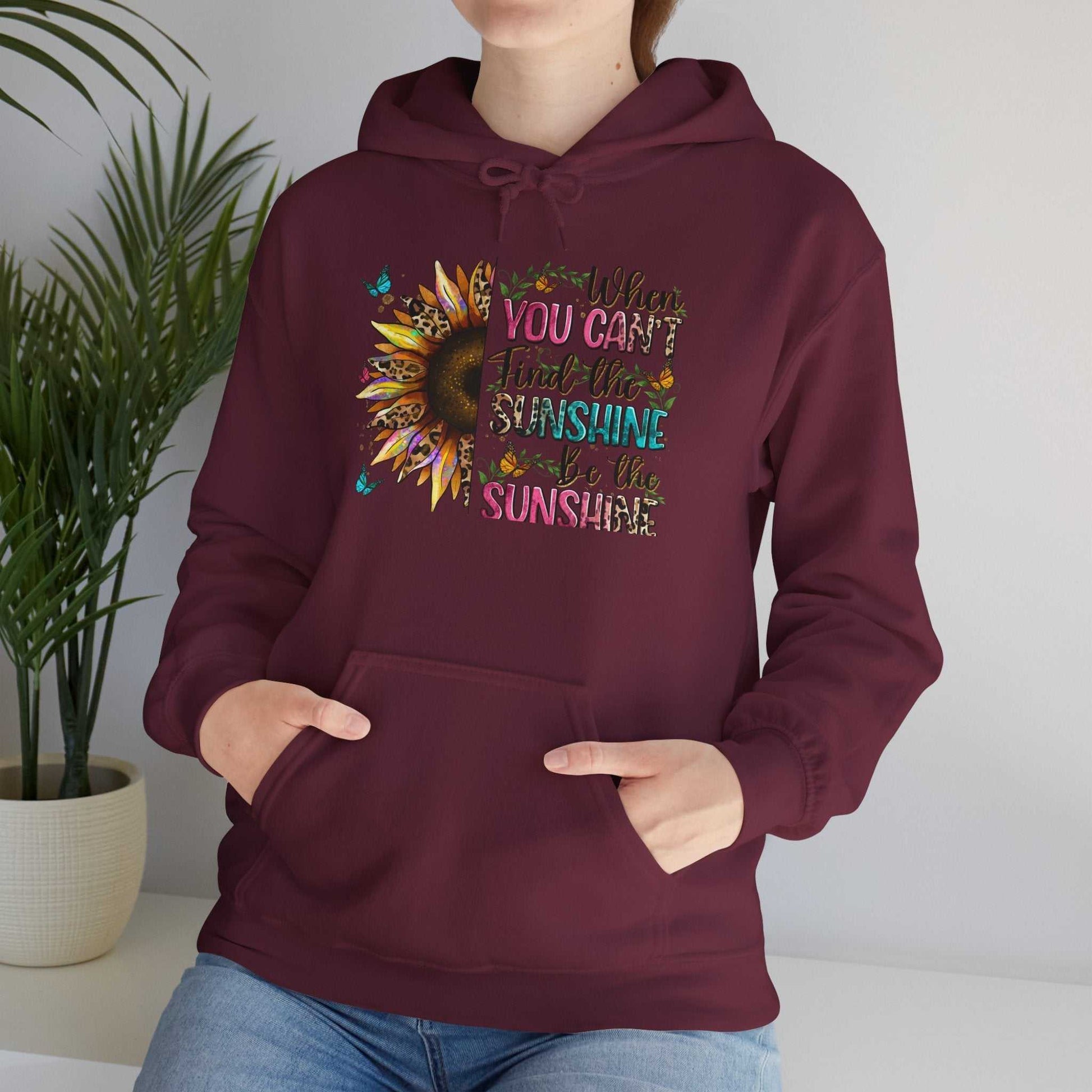 Maroon Sunflower Quote Hoodie with inspirational text and kangaroo pocket on casual model.