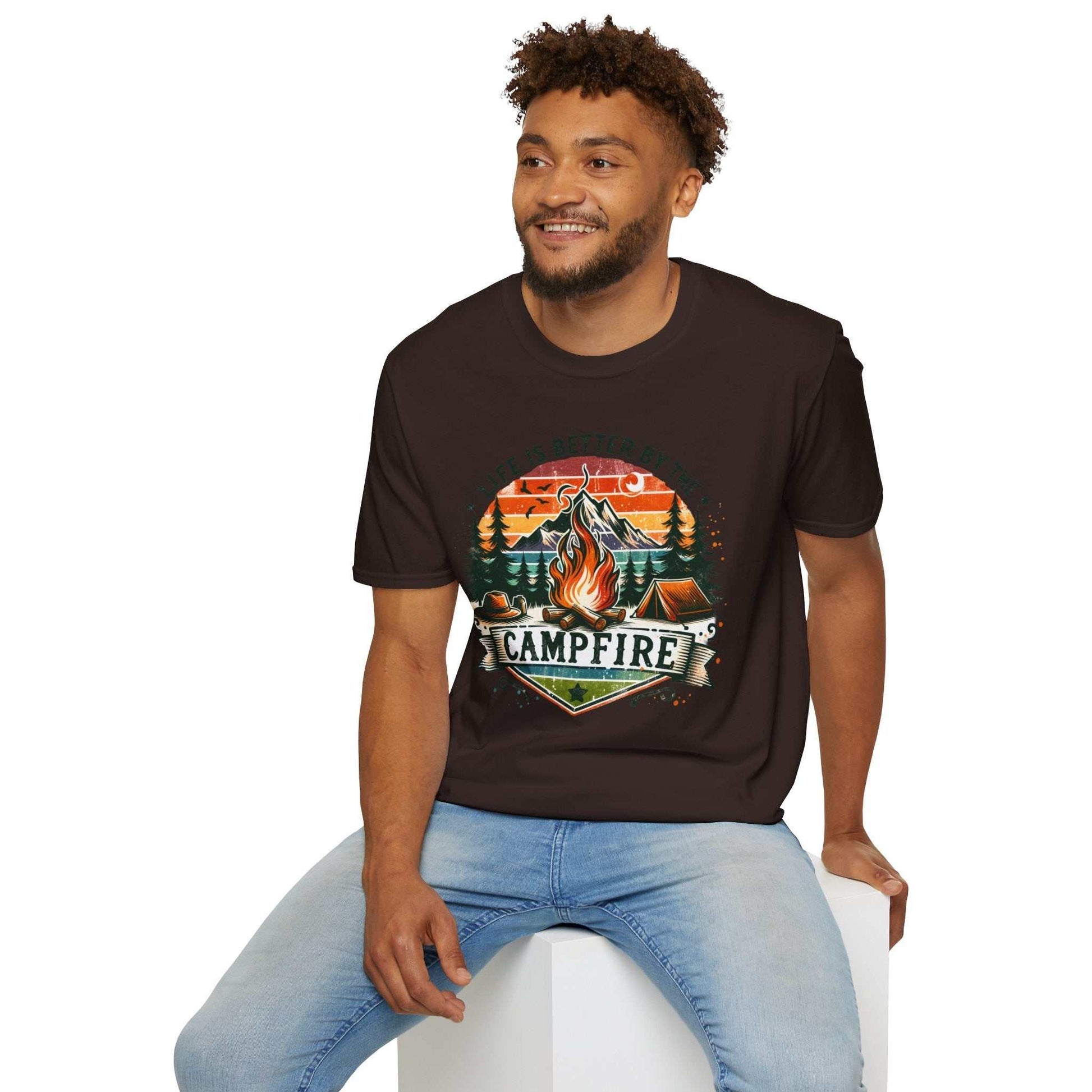 Man wearing black Camping Adventure Unisex T-Shirt with campfire graphic and nature scene.