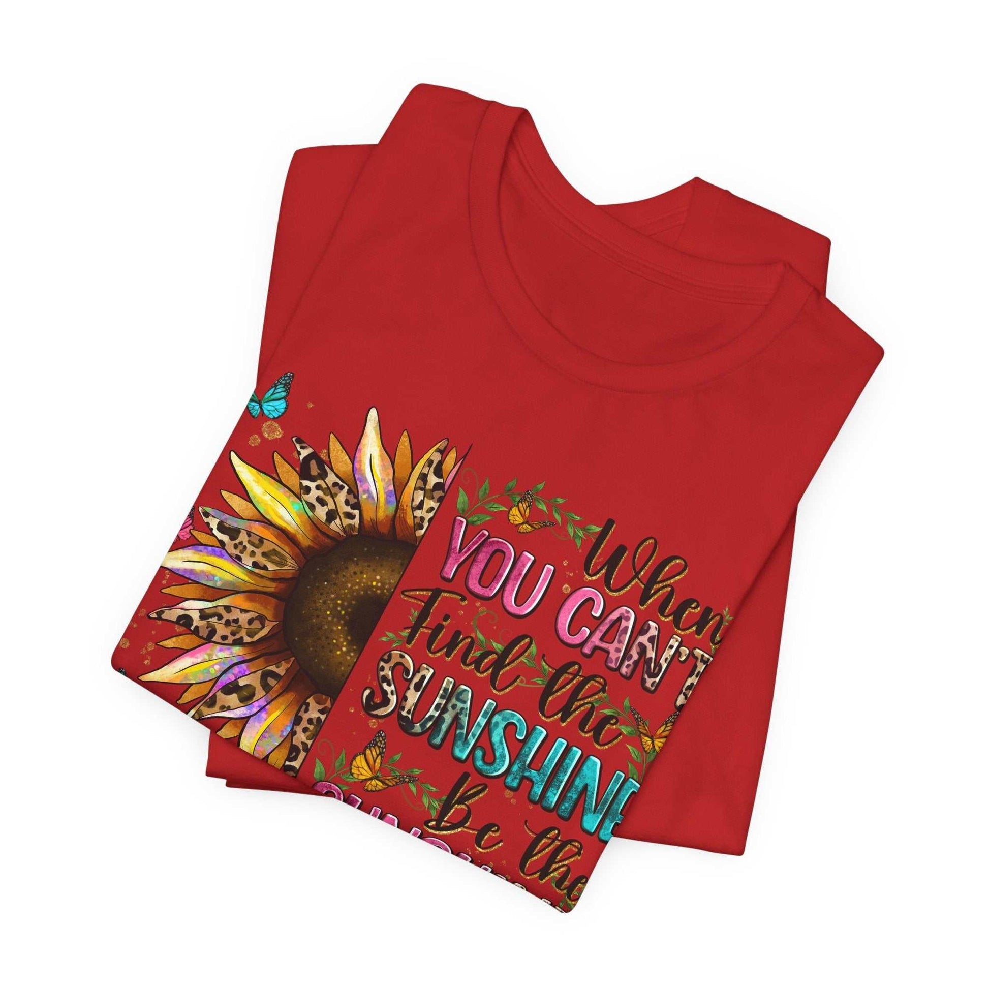 Red Sunshine Quote Tee with vibrant sunflower and colorful text design promoting positivity and joy.