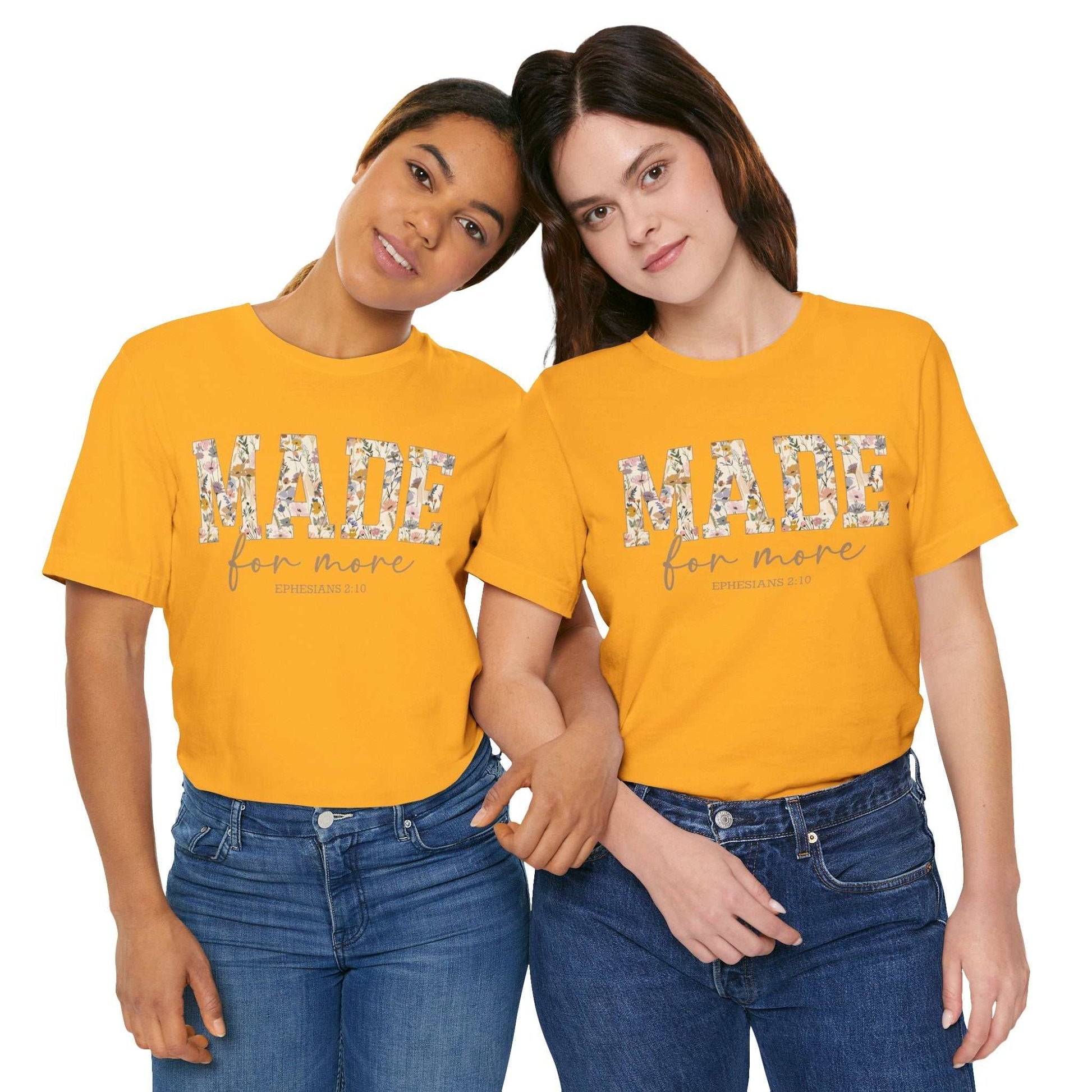 Two women wearing yellow Made for More Tee with floral print text and casual jeans