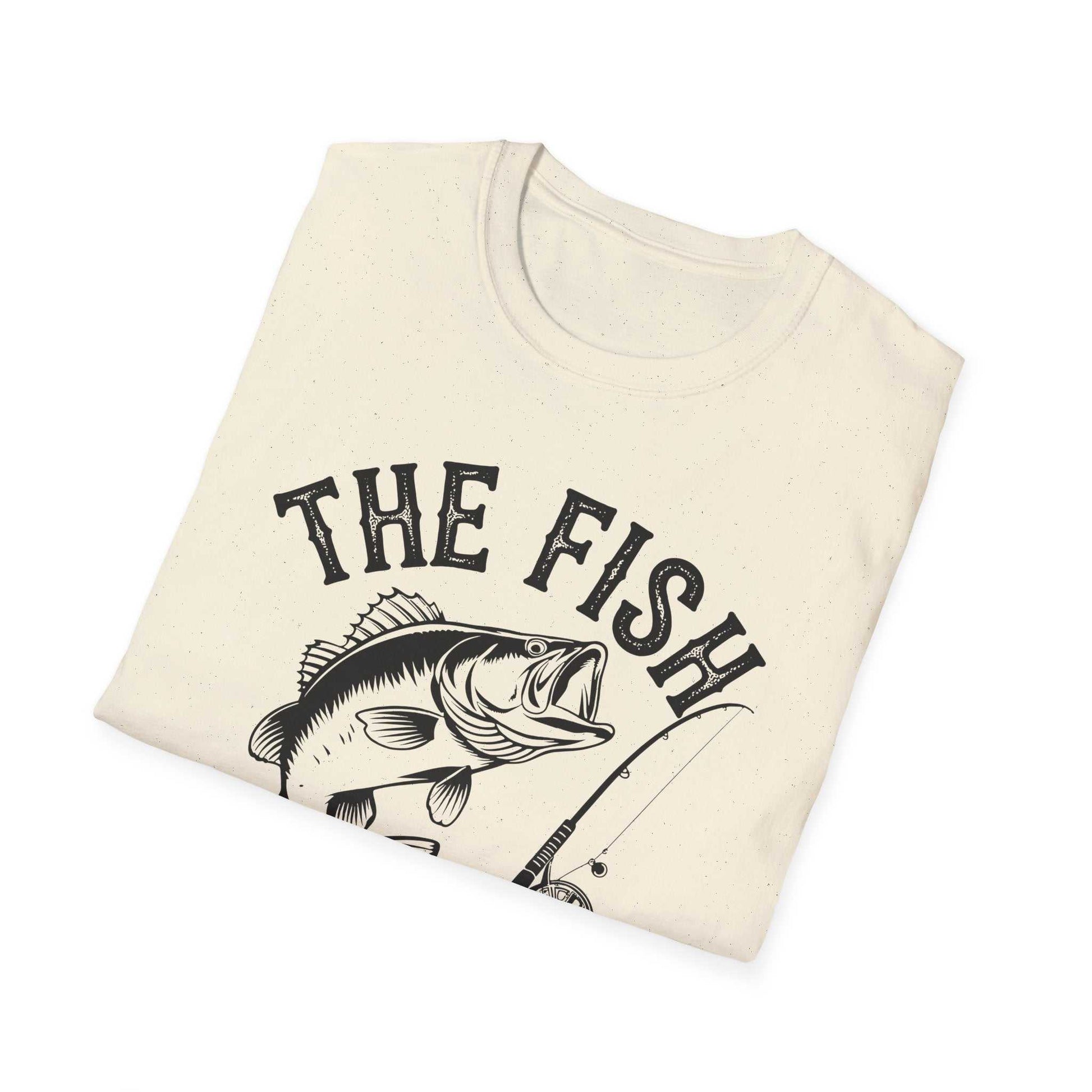 Folded beige unisex t-shirt with black graphic design of a fish and fishing rod and text "The Fish Whisperer"