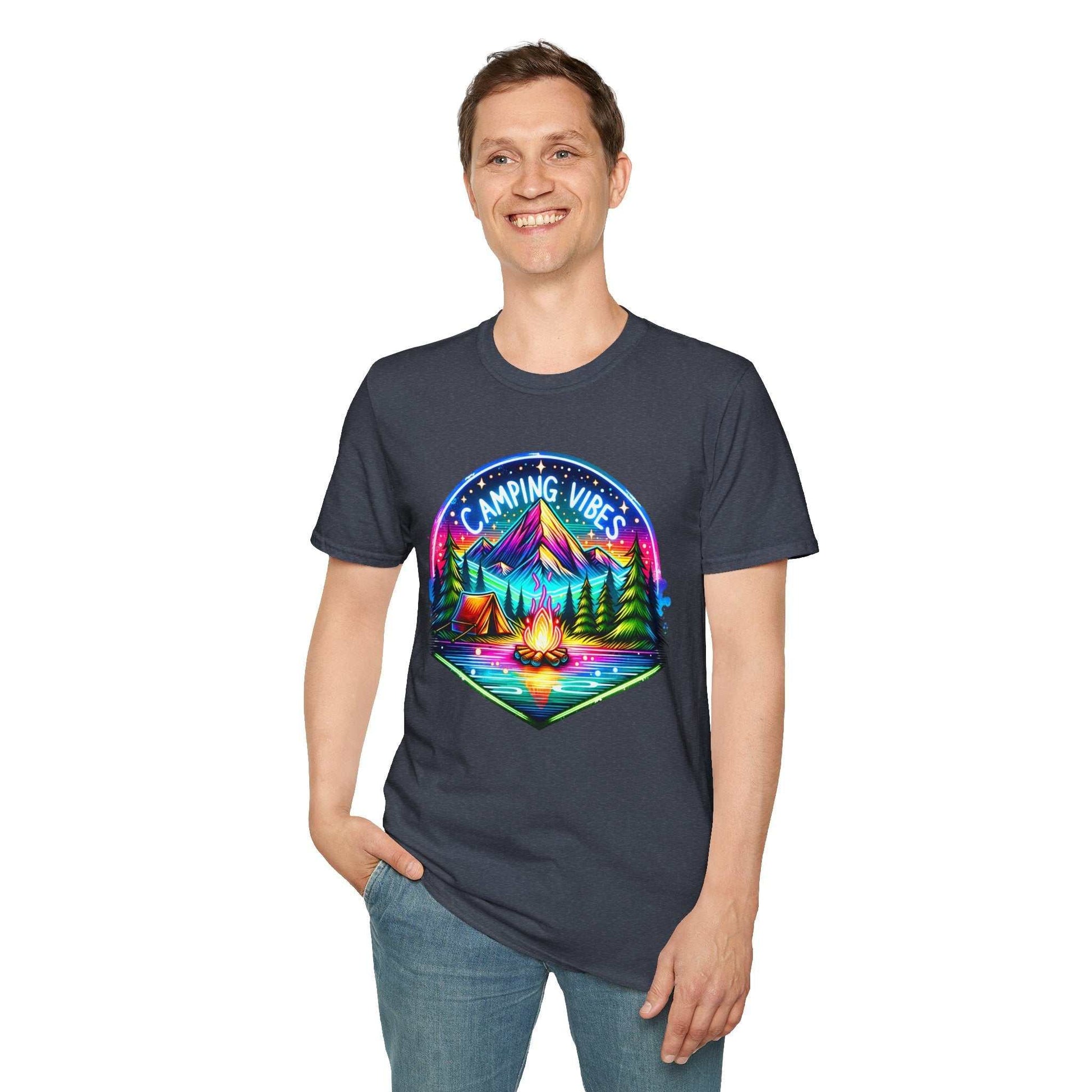 Man wearing a dark unisex softstyle t-shirt with colorful Camping Vibes design featuring mountains, campfire, and tents