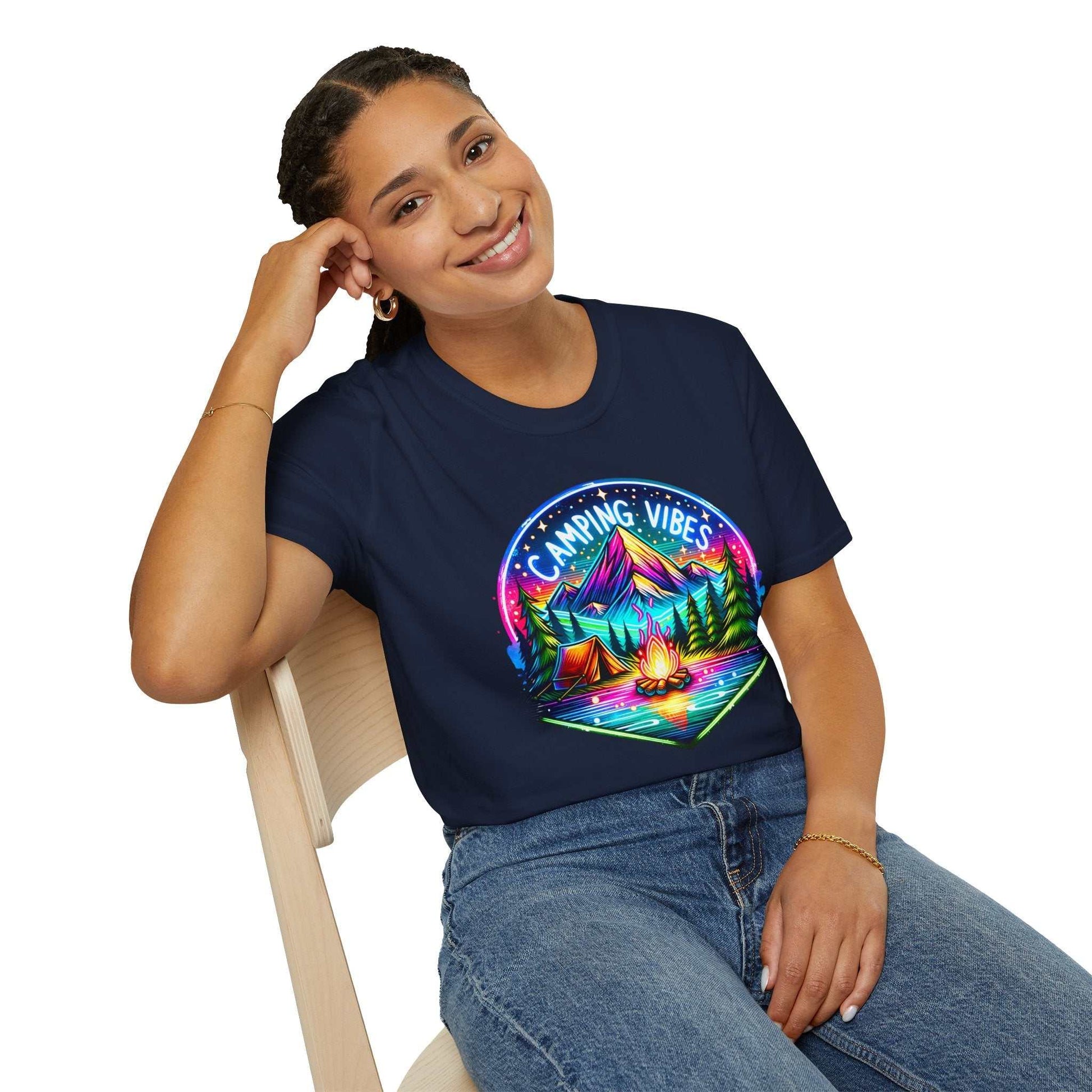 Woman wearing navy Camping Vibes Unisex softstyle t-shirt with colorful campfire and mountain graphic