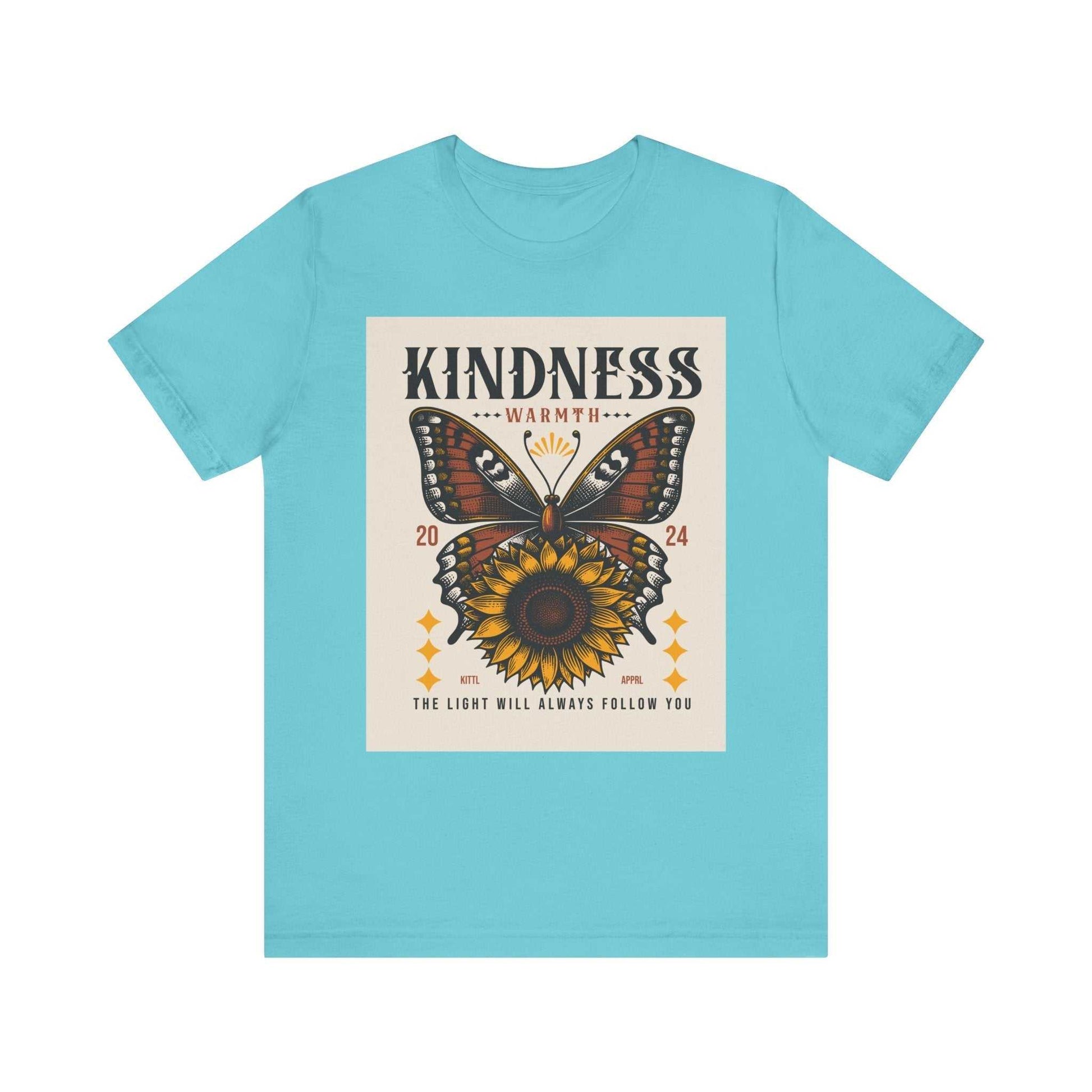 Light blue Kindness Butterfly Tee featuring a butterfly and sunflower graphic with the text "Kindness Warmth 2024 The light will always follow you" on the front.