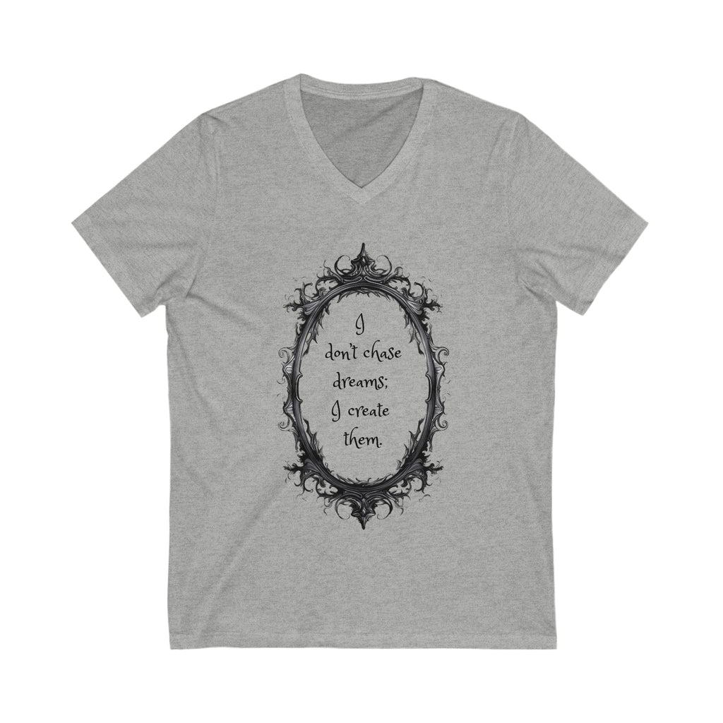Gray unisex V-neck tee with motivational quote "I don't chase dreams; I create them" inside ornate oval frame