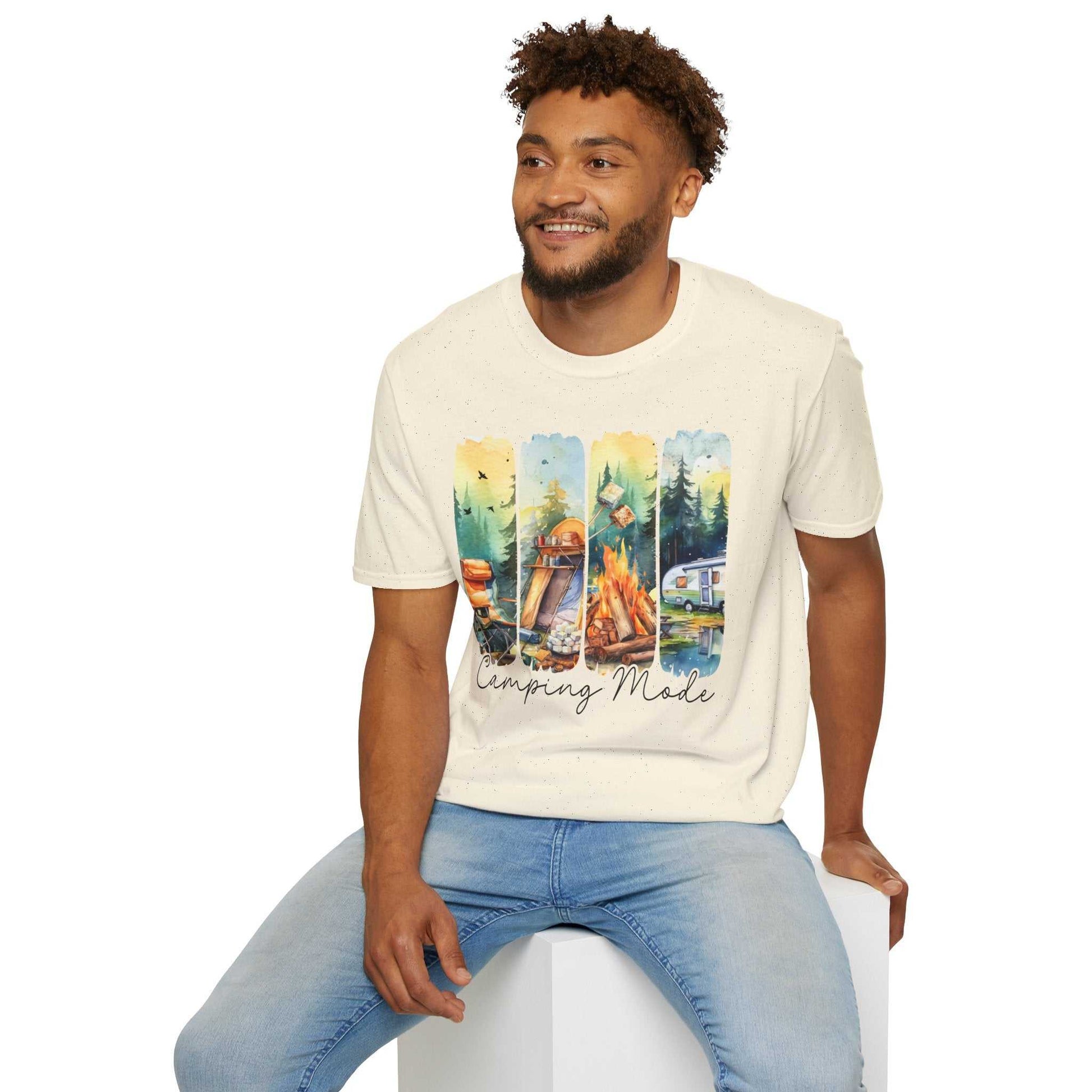 Man wearing a cream Camping Adventure Unisex T-Shirt with a colorful camping-themed graphic and blue jeans