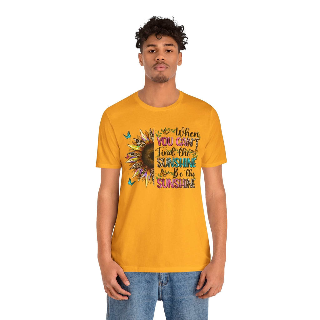 Man wearing bright yellow Sunshine Quote Tee with sunflower and positive quote graphic