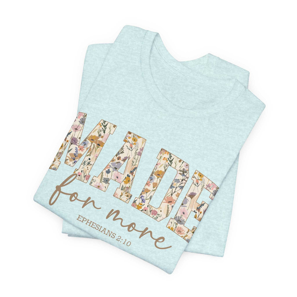 Folded light blue unisex short sleeve tee with floral "MADE for more" text and Ephesians 2:10 scripture design