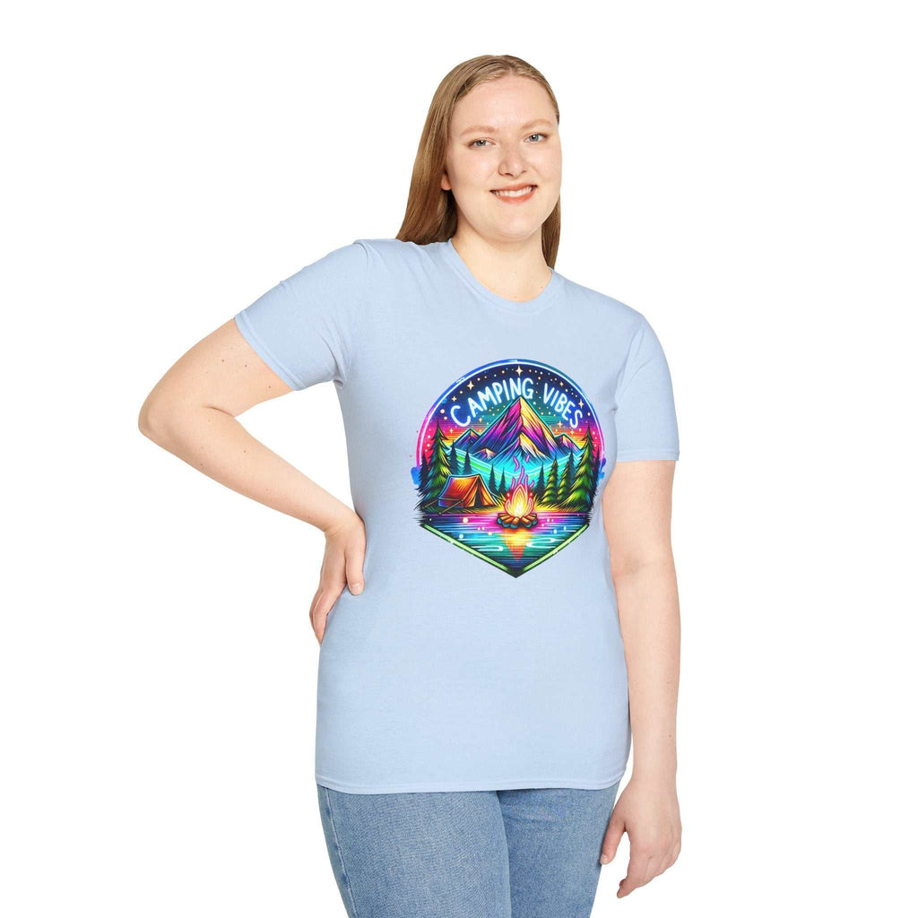 Unisex softstyle t-shirt in light blue featuring a colorful "Camping Vibes" graphic with mountains, trees, tents, and a campfire.