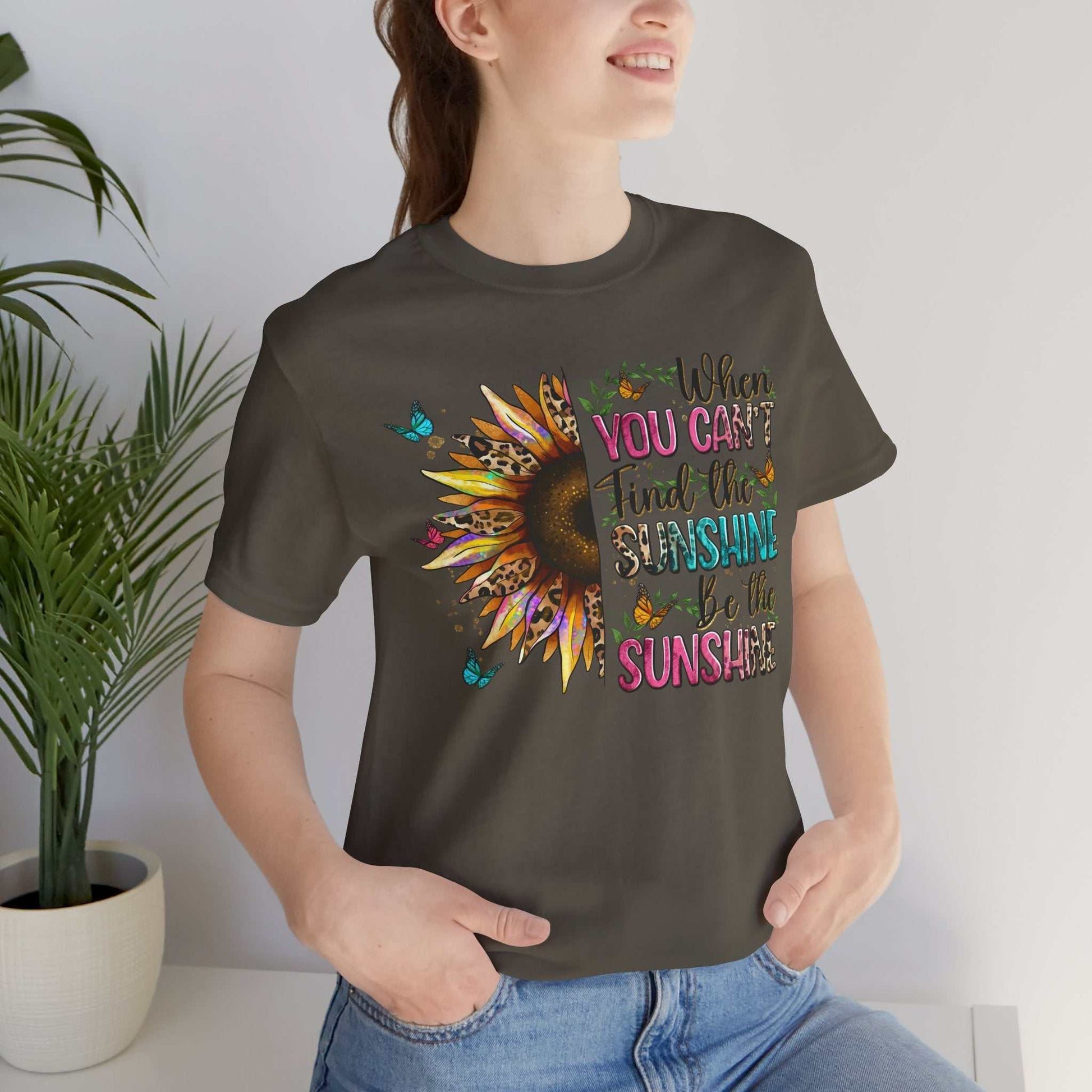 woman wearing dark sunshine quote tee with colorful sunflower and motivational text design