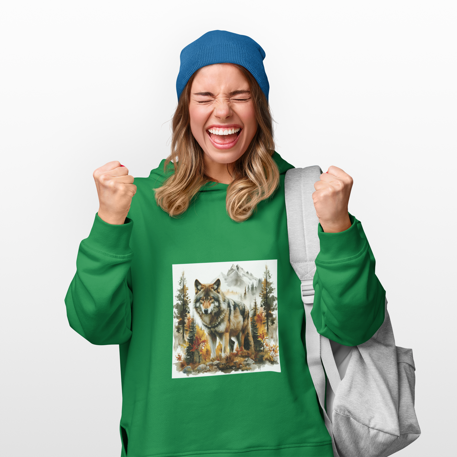Woman wearing green Wilderness Wolf Hoodie with wolf and forest print, blue beanie, and gray backpack, celebrating outdoors style