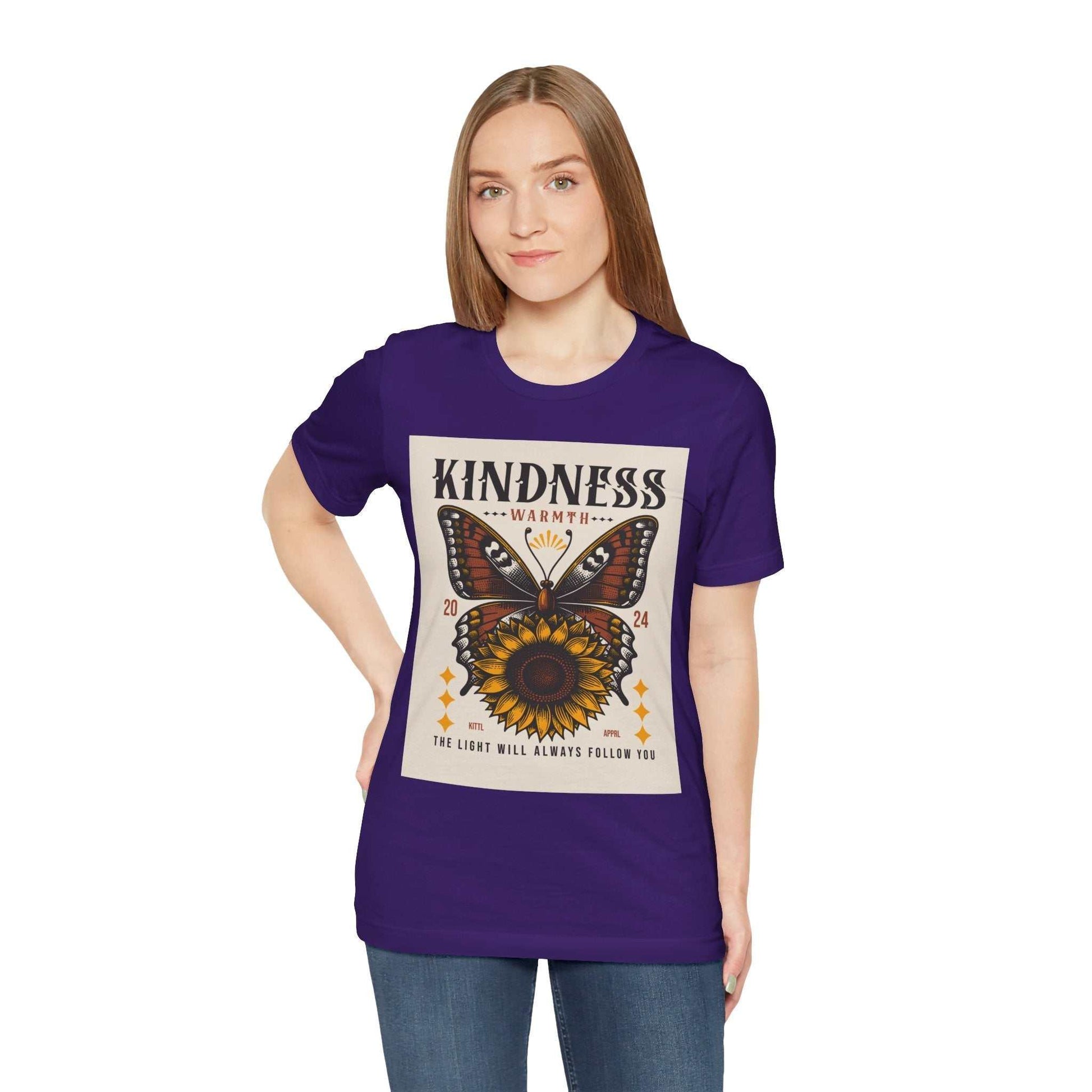Woman wearing a purple Kindness Butterfly Tee with a butterfly and sunflower graphic and inspirational text on the front