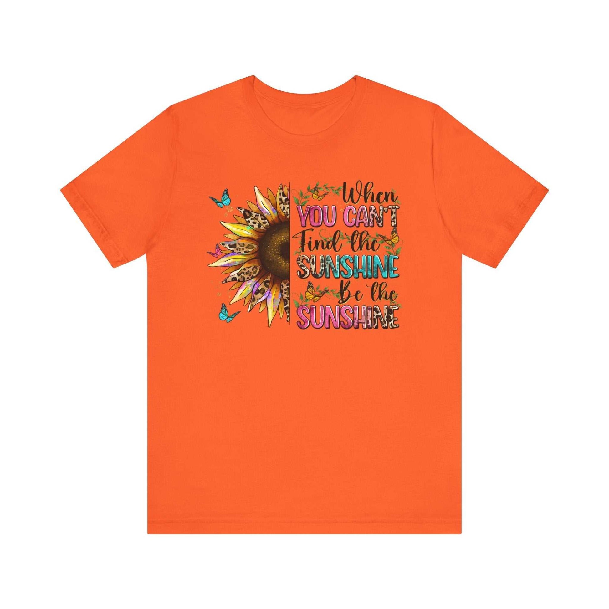 Orange unisex Sunshine Quote Tee with sunflower and butterfly graphic and motivational text design