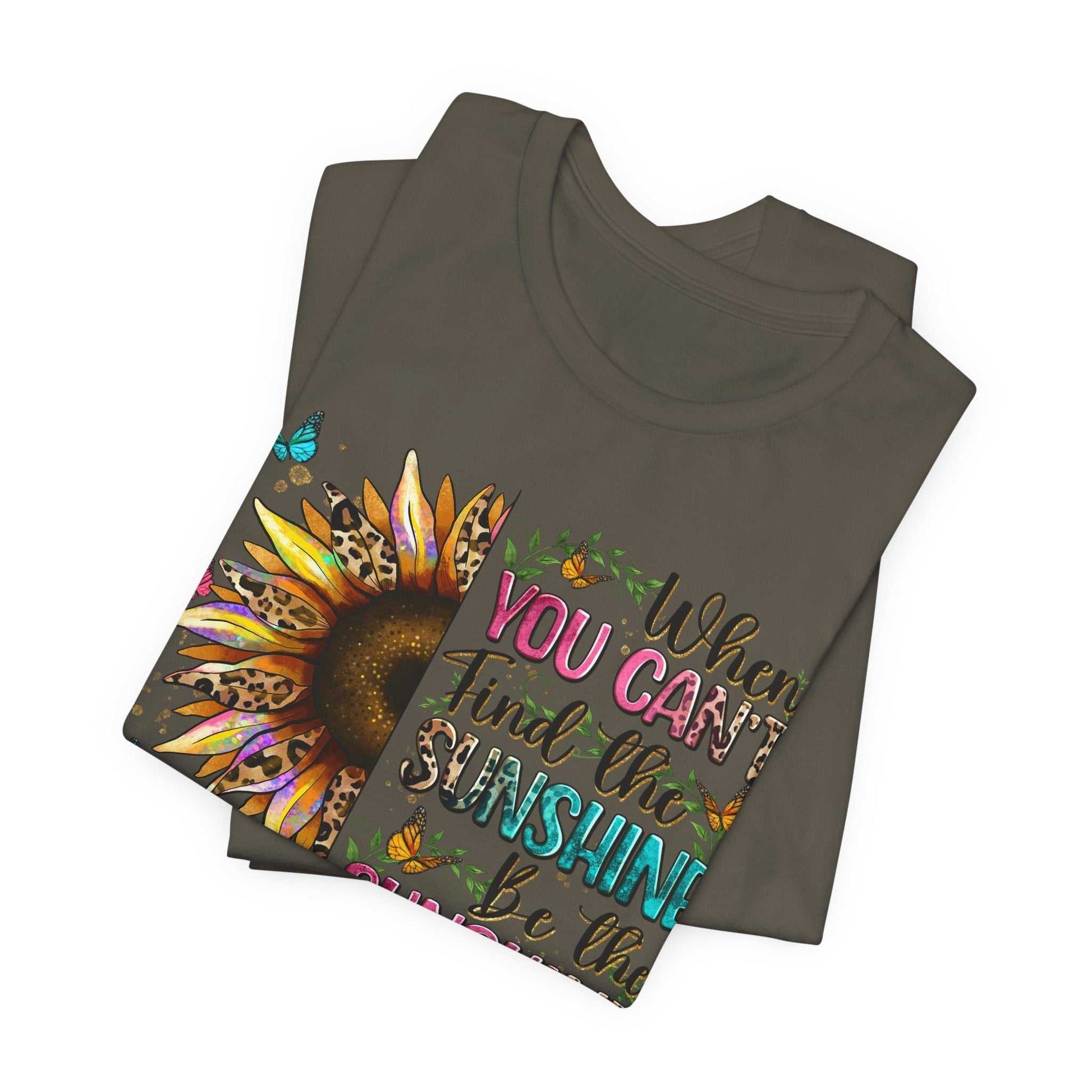 Folded charcoal Sunshine Quote Tee with colorful sunflower and motivational text design