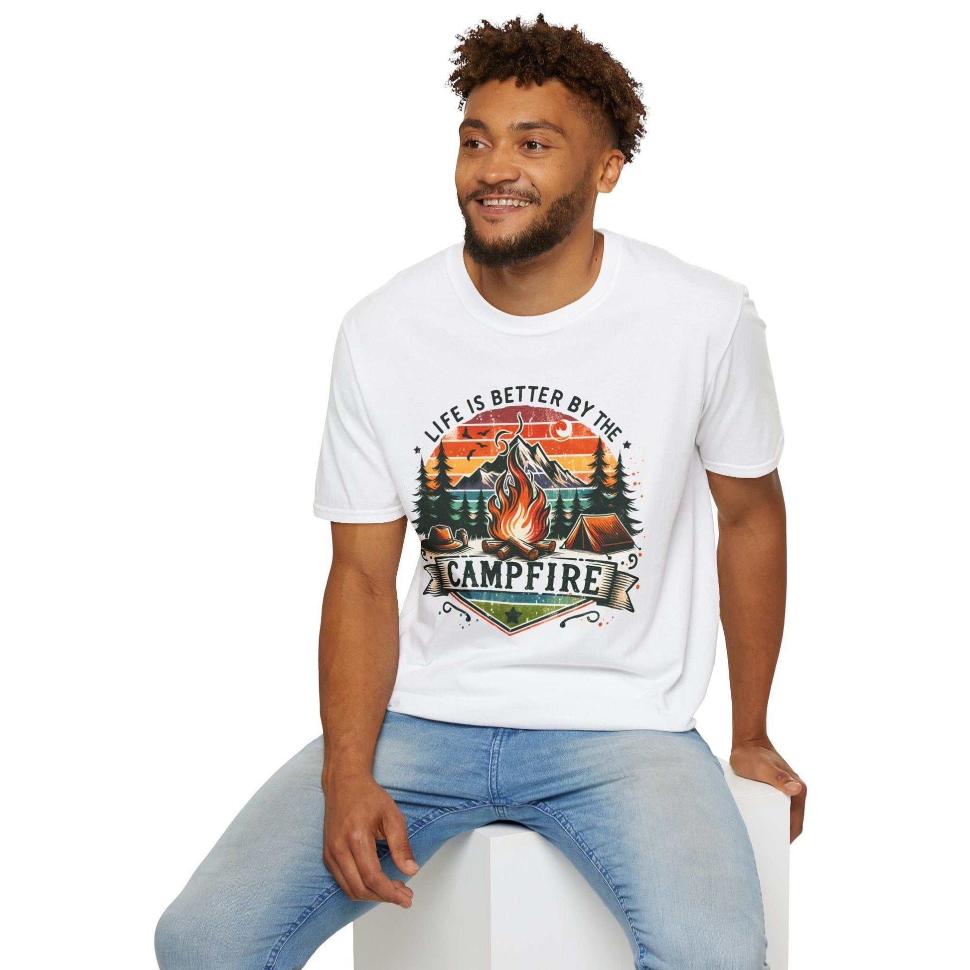 Camping Adventure Unisex T-Shirt white with vibrant campfire design and "Life is Better by the Campfire" text, worn by smiling man