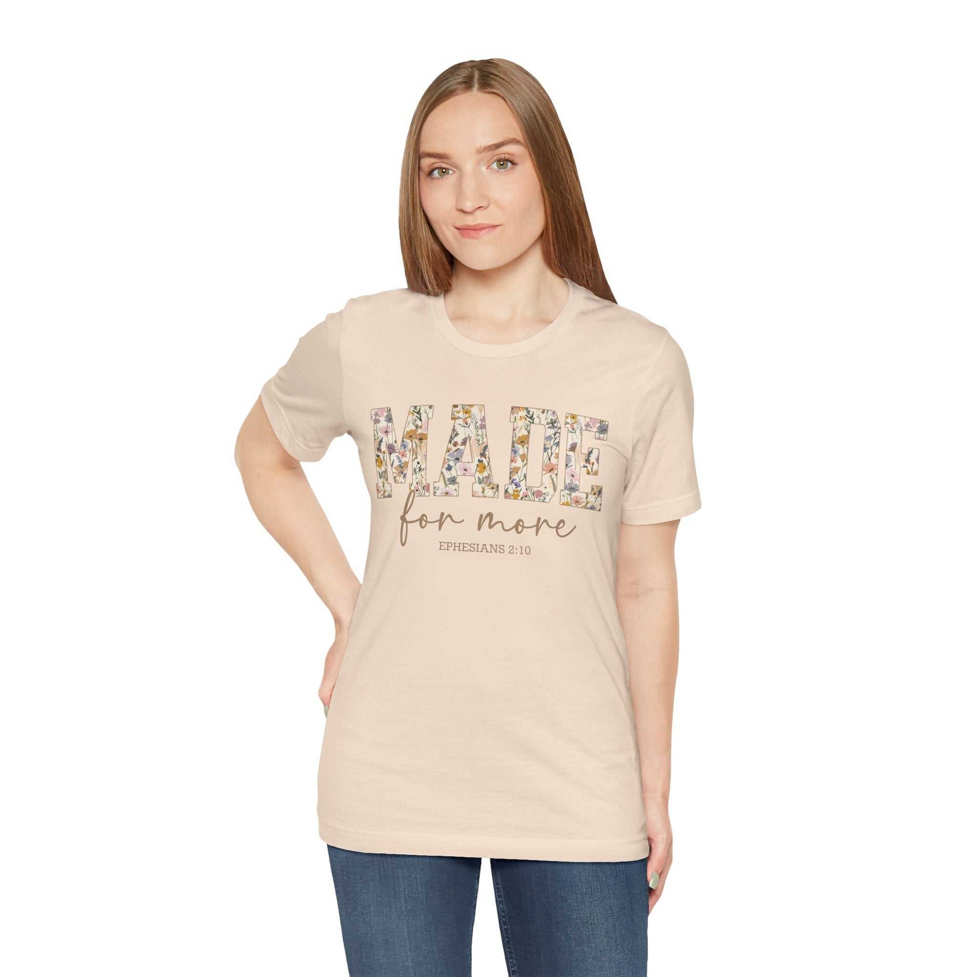 Woman wearing beige Made for More Tee with floral text design and casual fit