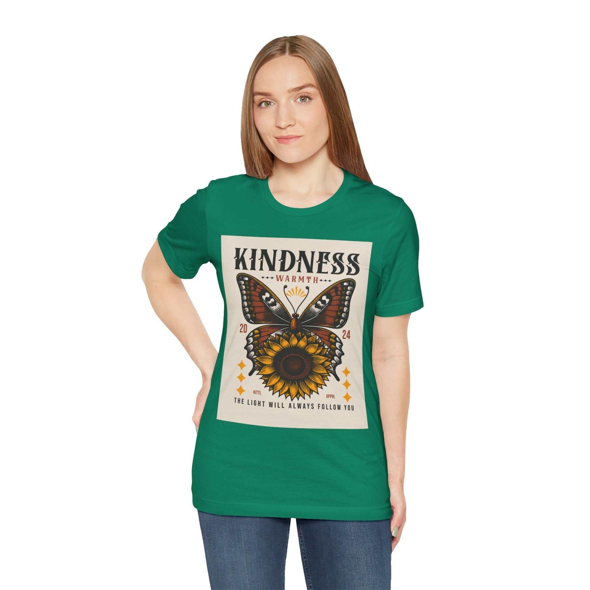 Woman wearing green Kindness Butterfly Tee with butterfly and sunflower graphic and positive message