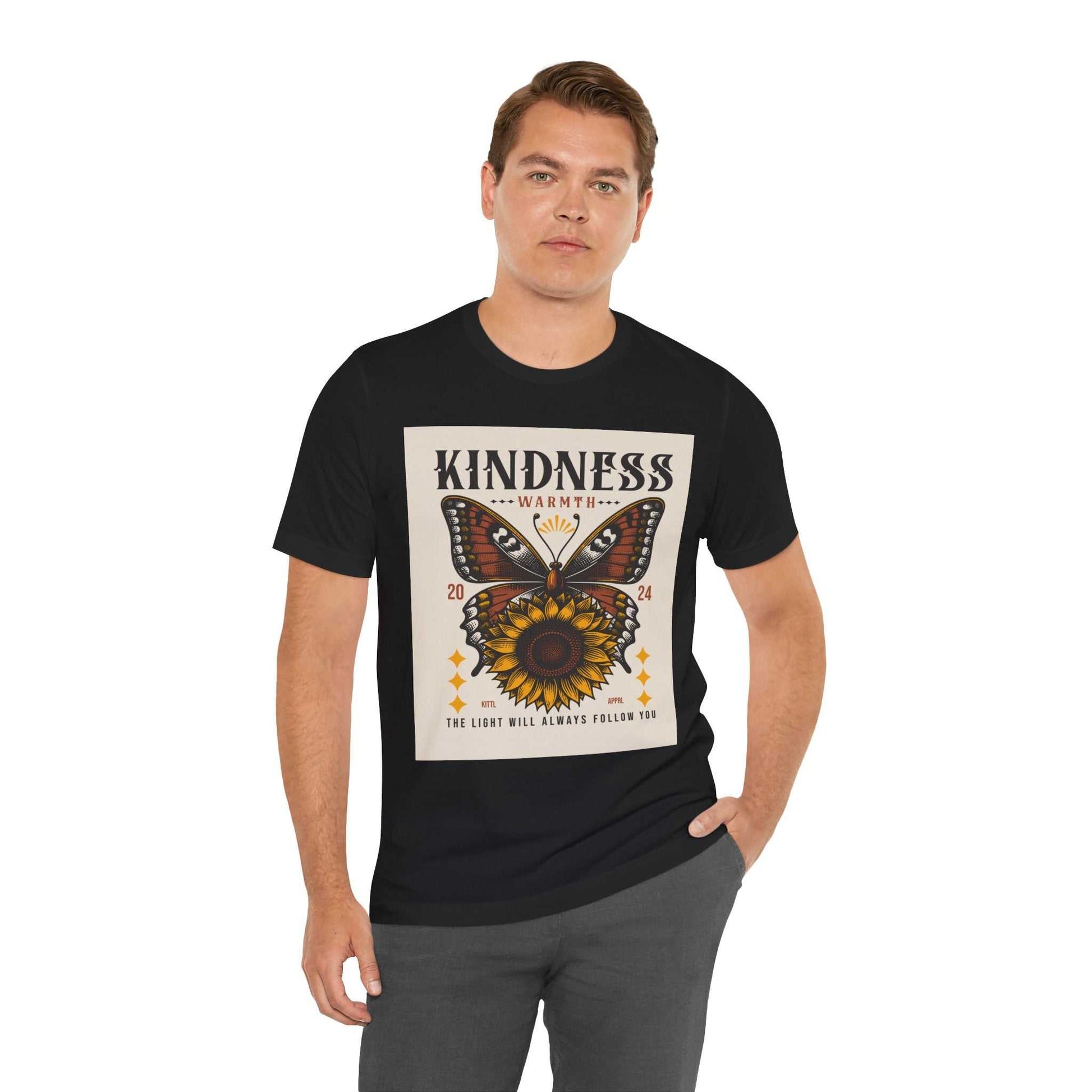 Man wearing black Kindness Butterfly Tee with butterfly and sunflower design and positive message on front
