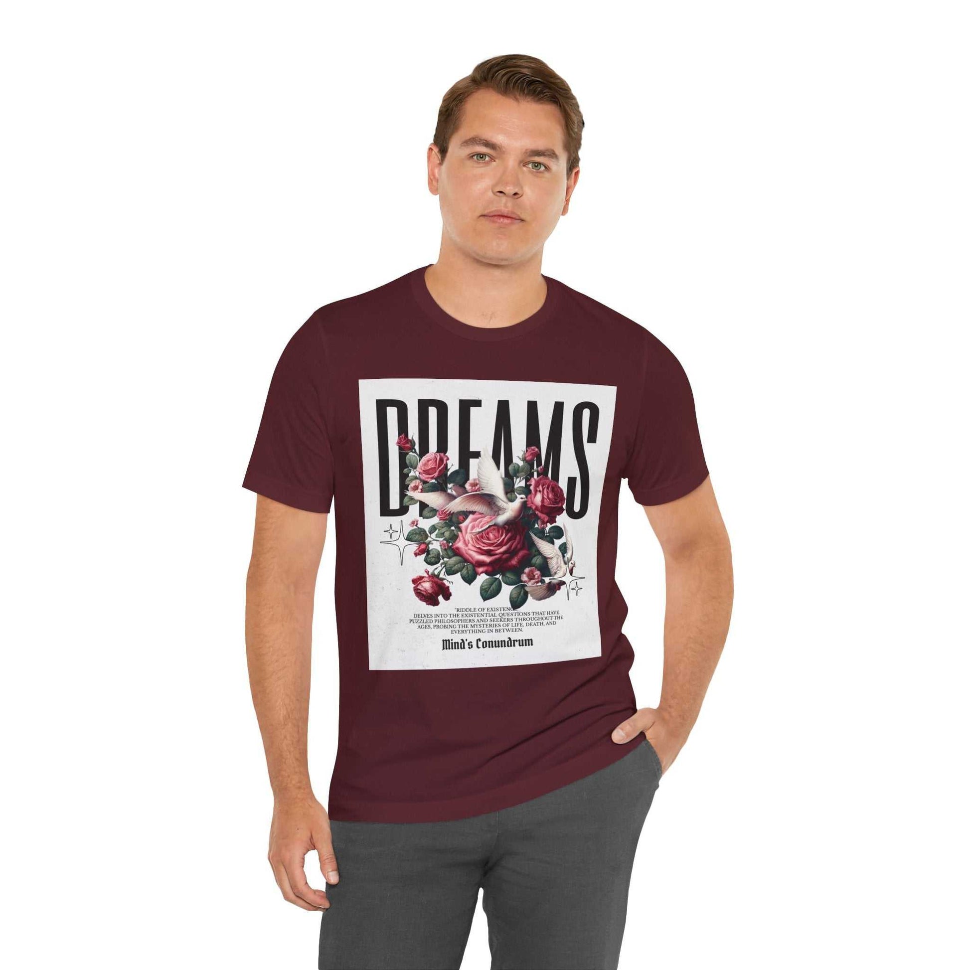 Man wearing maroon Dreams Floral Tee with large floral and text graphic on front