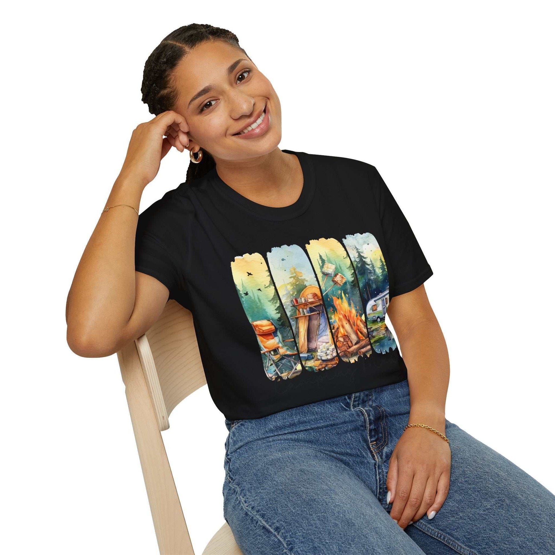 Woman wearing a black Camping Adventure Unisex T-Shirt with a colorful outdoor camping design sitting on a wooden chair