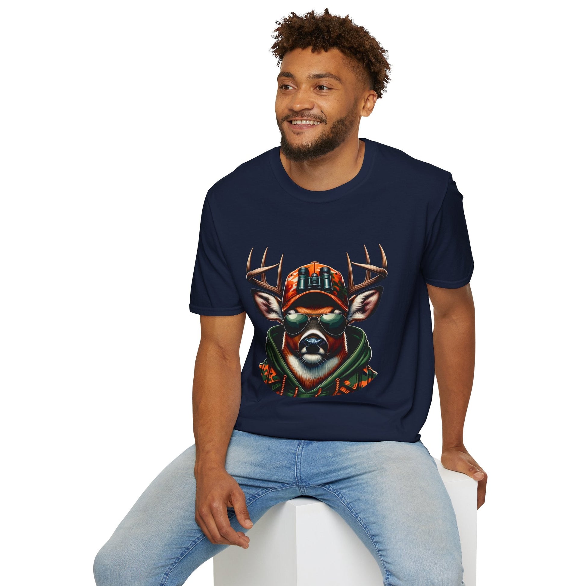 Man wearing navy Hunting Enthast T-Shirt with cool deer graphic design sitting on white block