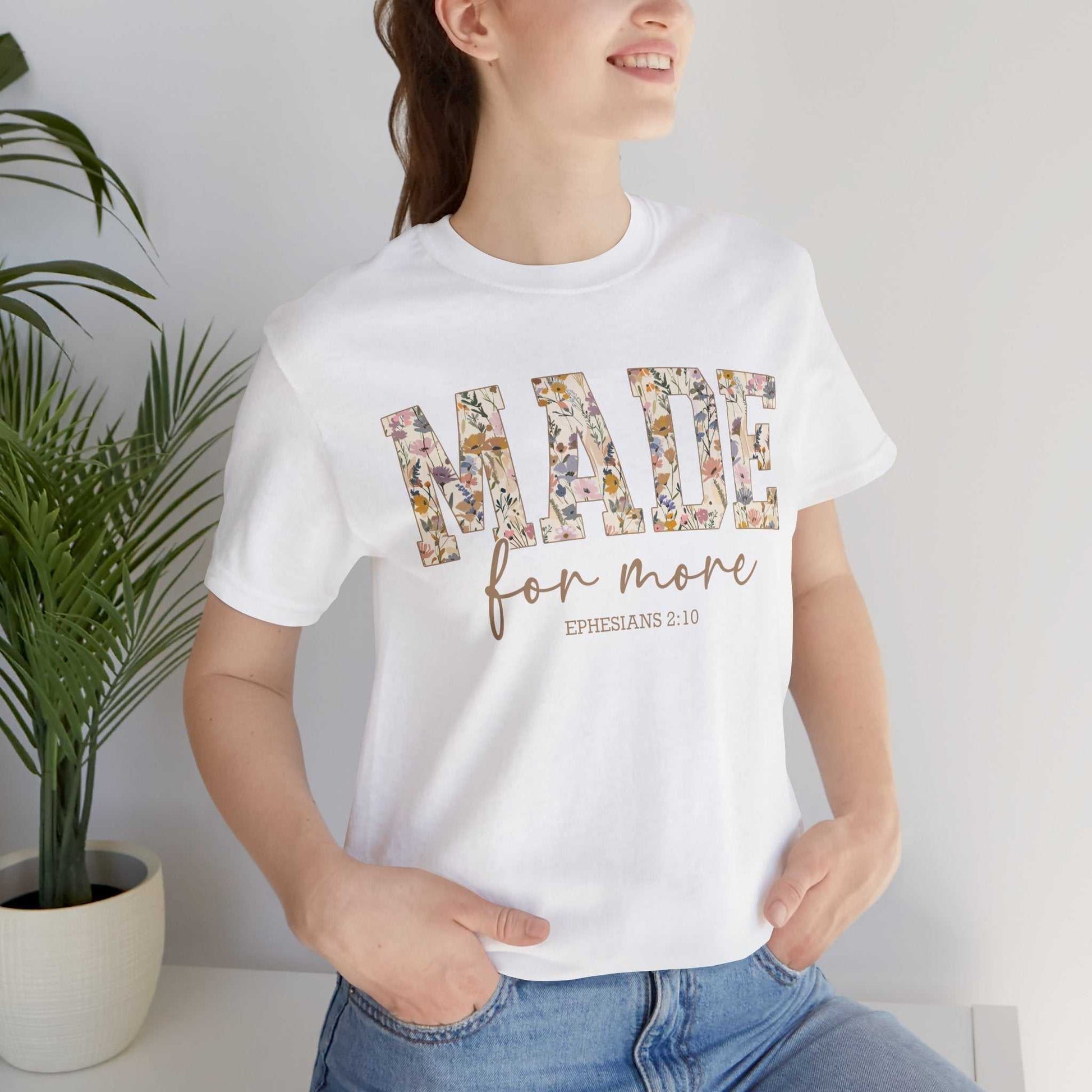 woman wearing white Made for More Tee with floral print text and Ephesians 2:10 design