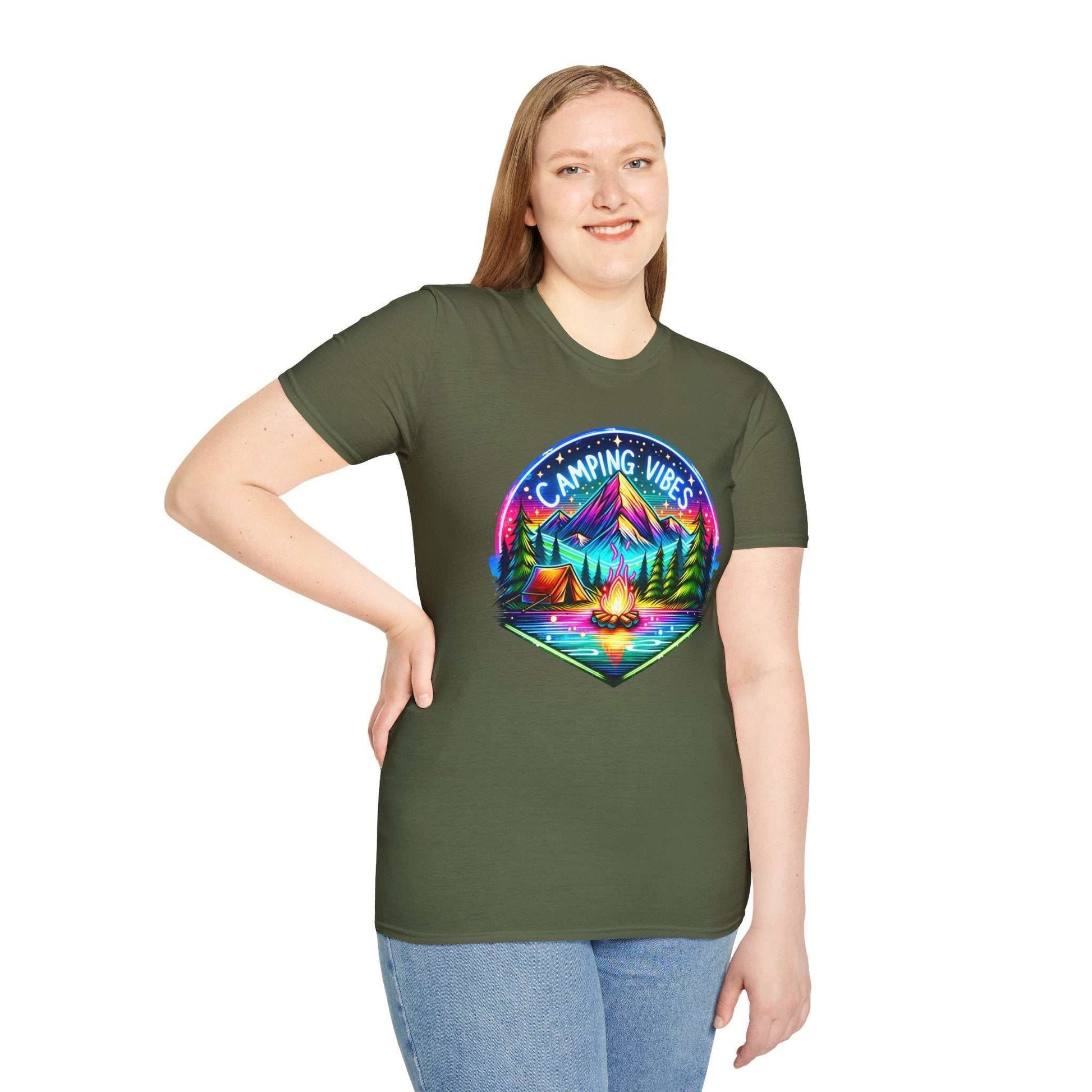 Woman wearing green Camping Vibes Unisex Softstyle T-Shirt with colorful mountain and campfire graphic