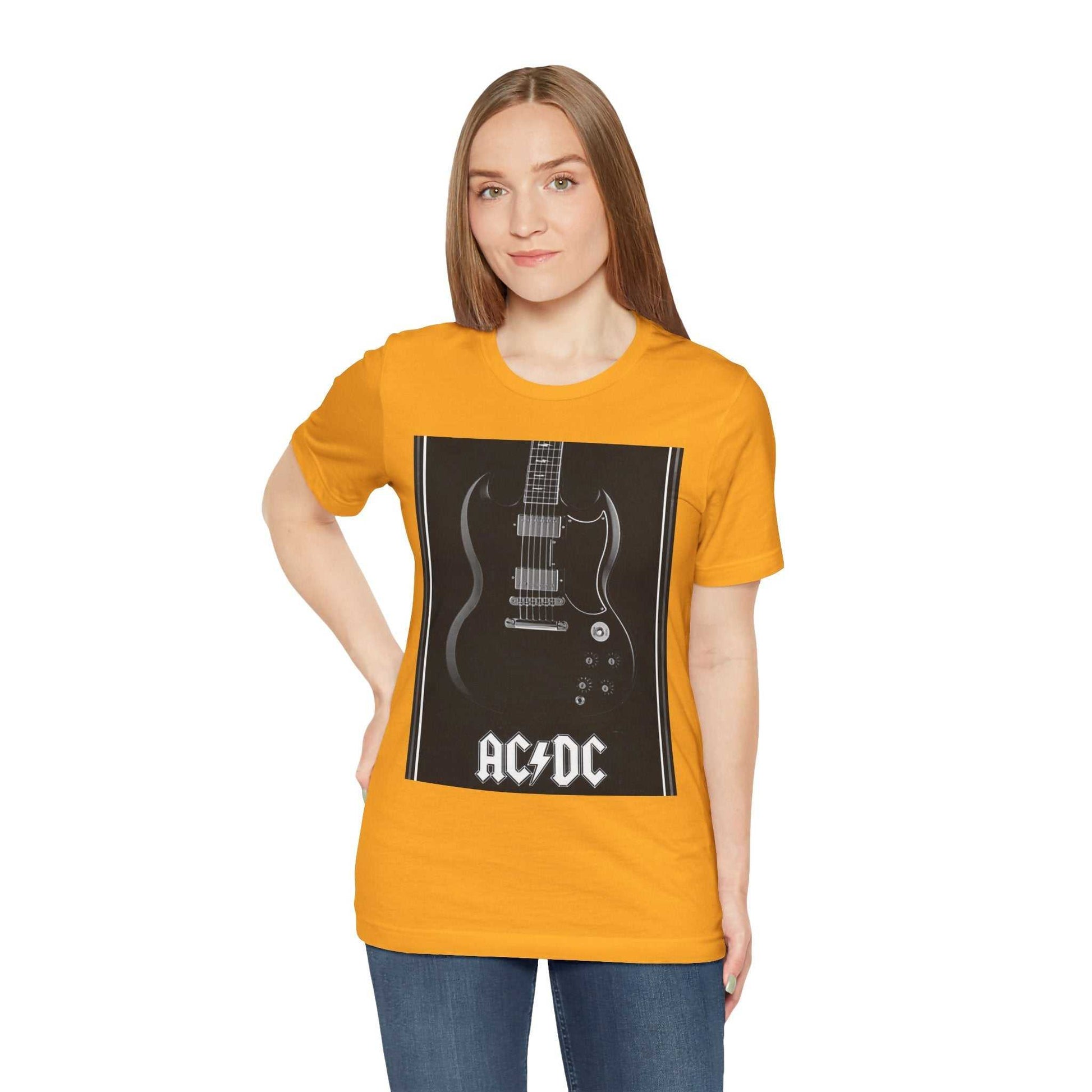 Woman wearing an orange rock guitar graphic tee featuring a black and white electric guitar and AC/DC logo design.