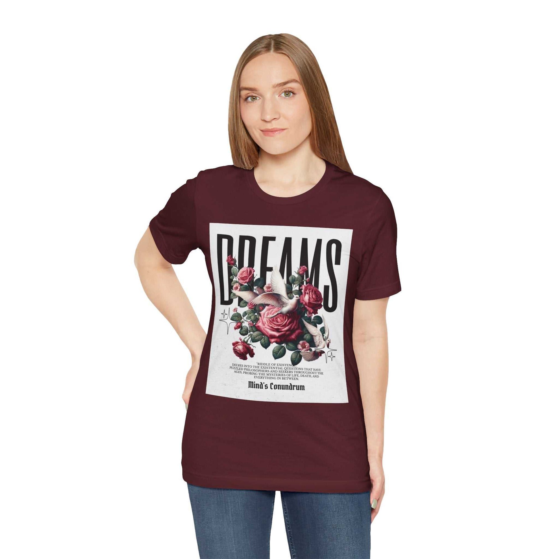 Woman wearing a maroon Dreams Floral Tee with a floral and typography design on the front.