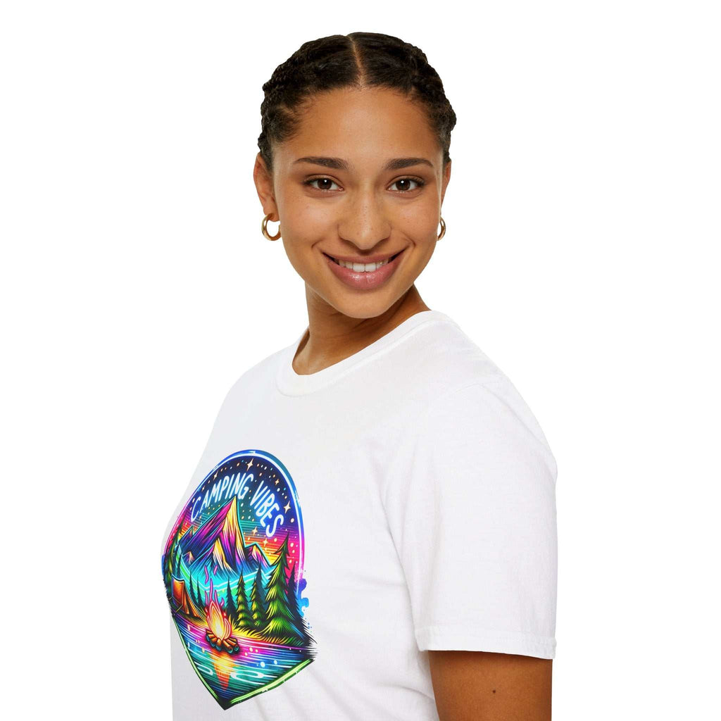 Woman wearing a white Camping Vibes Unisex Softstyle T-Shirt with colorful nature and campfire graphic on front