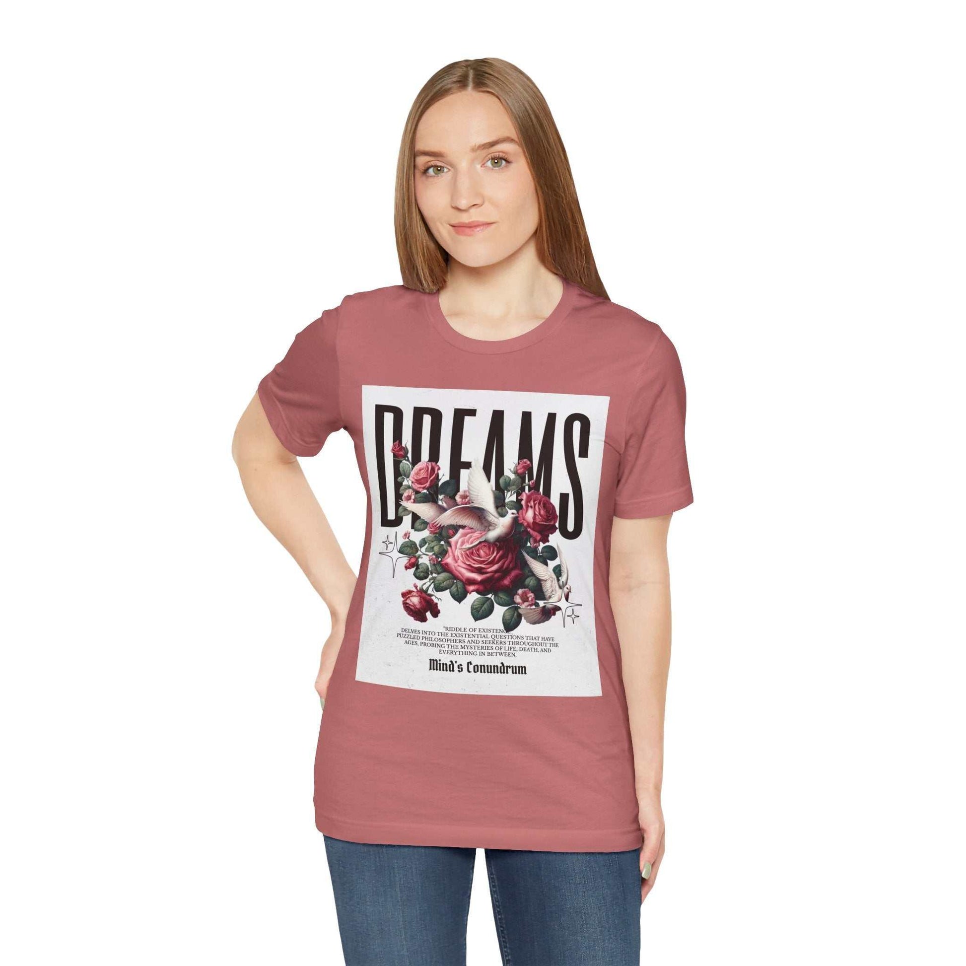 Woman wearing a pink Dreams Floral Tee with large floral graphic and bold text on front
