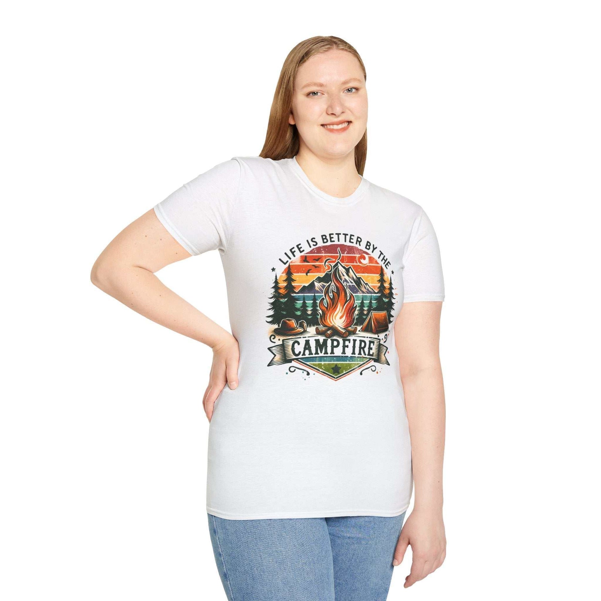 Unisex white Camping Adventure T-shirt with vibrant campfire graphic and "Life is Better by the Campfire" text, worn by smiling model.