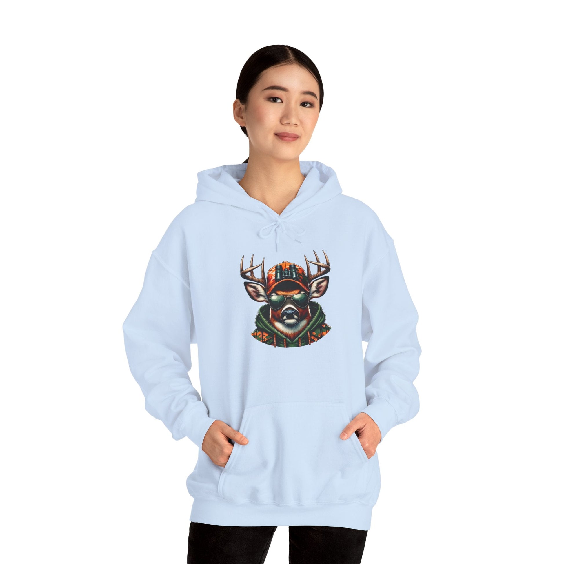 Woman wearing light blue hooded sweatshirt with bold deer graphic design on front and kangaroo pocket