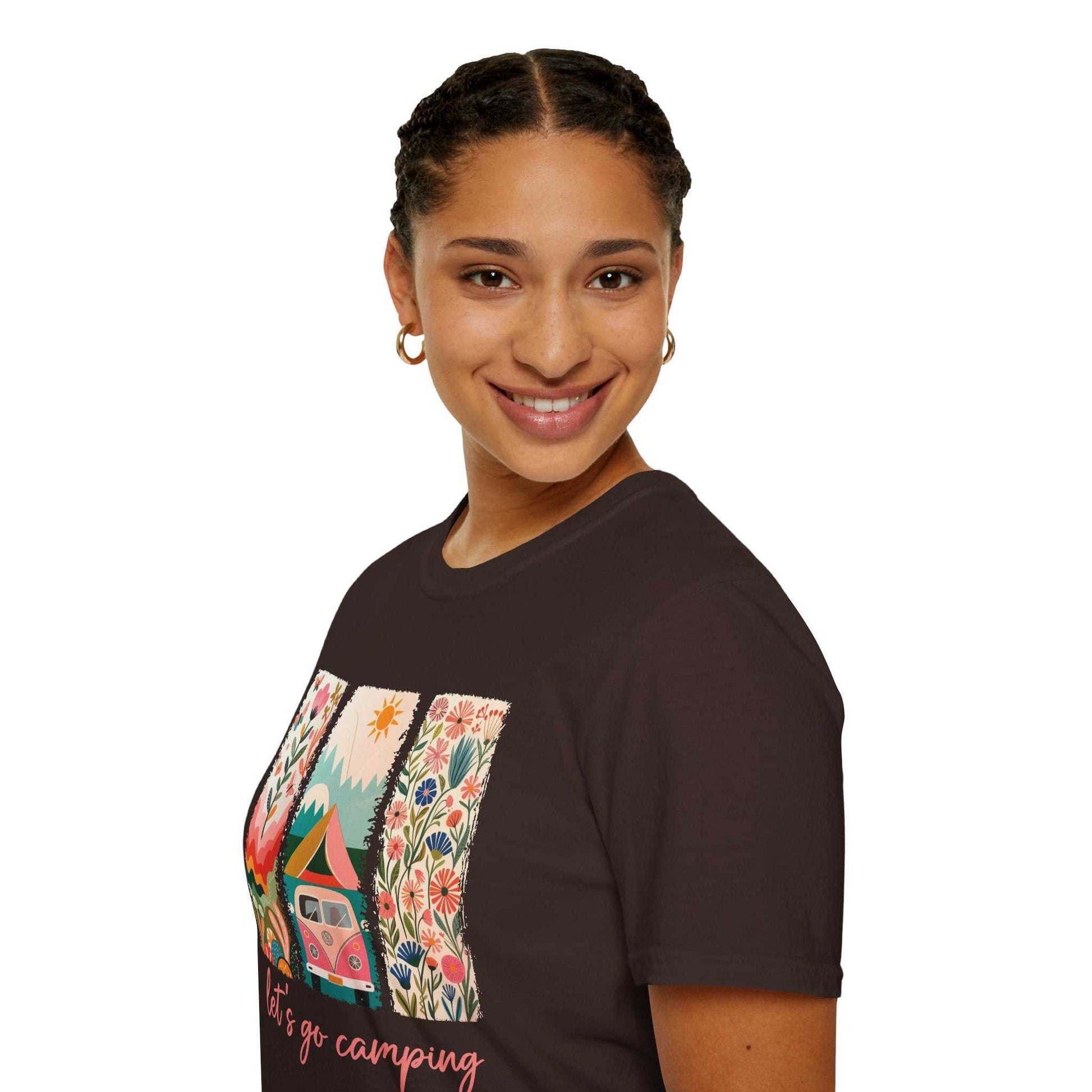 Woman wearing a unisex softstyle t-shirt with colorful camping adventure design on front