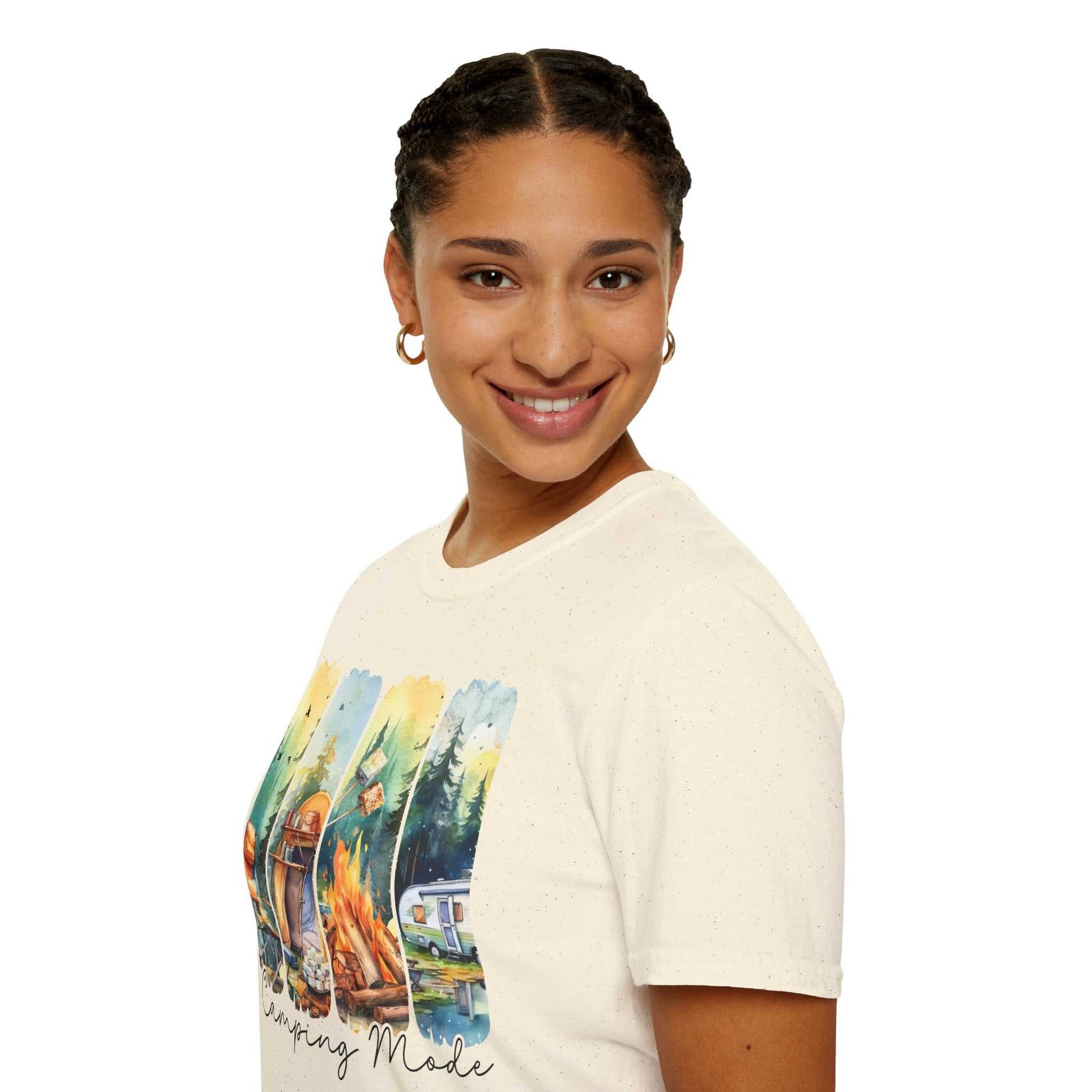 Woman wearing a cream-colored Camping Adventure Unisex T-Shirt with a colorful camping design on front, smiling and posing against white background