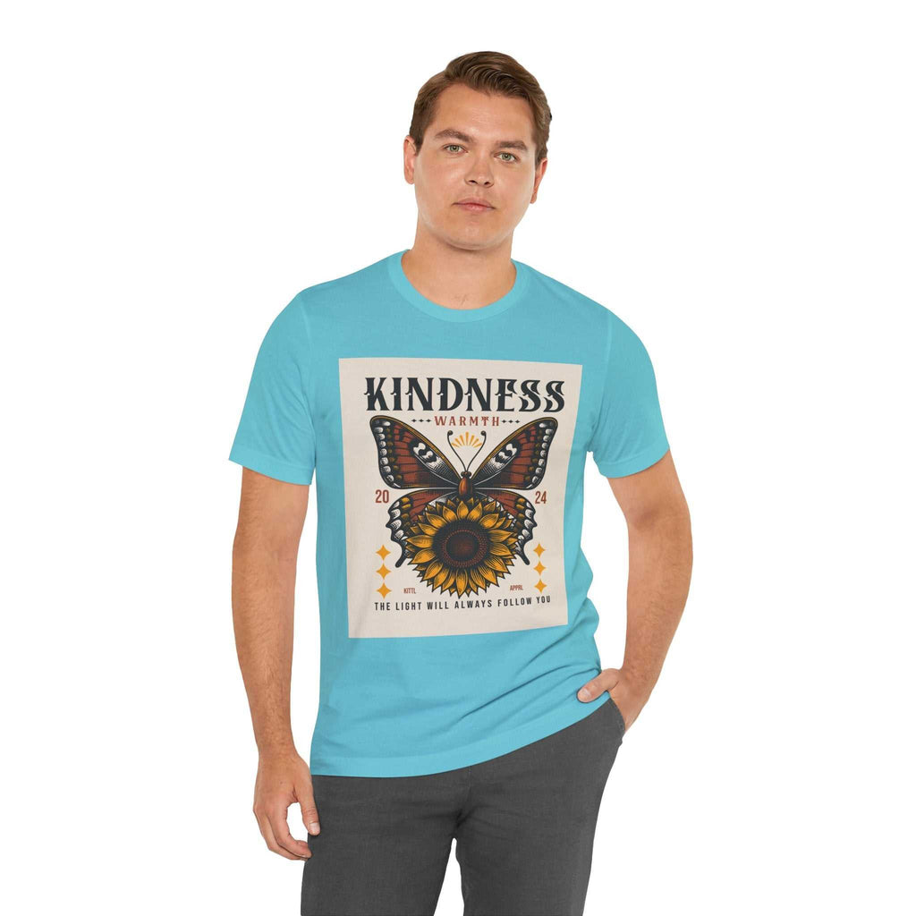 Man wearing a light blue Kindness Butterfly Tee with butterfly and sunflower graphic and text "Kindness Warmth The Light Will Always Follow You"