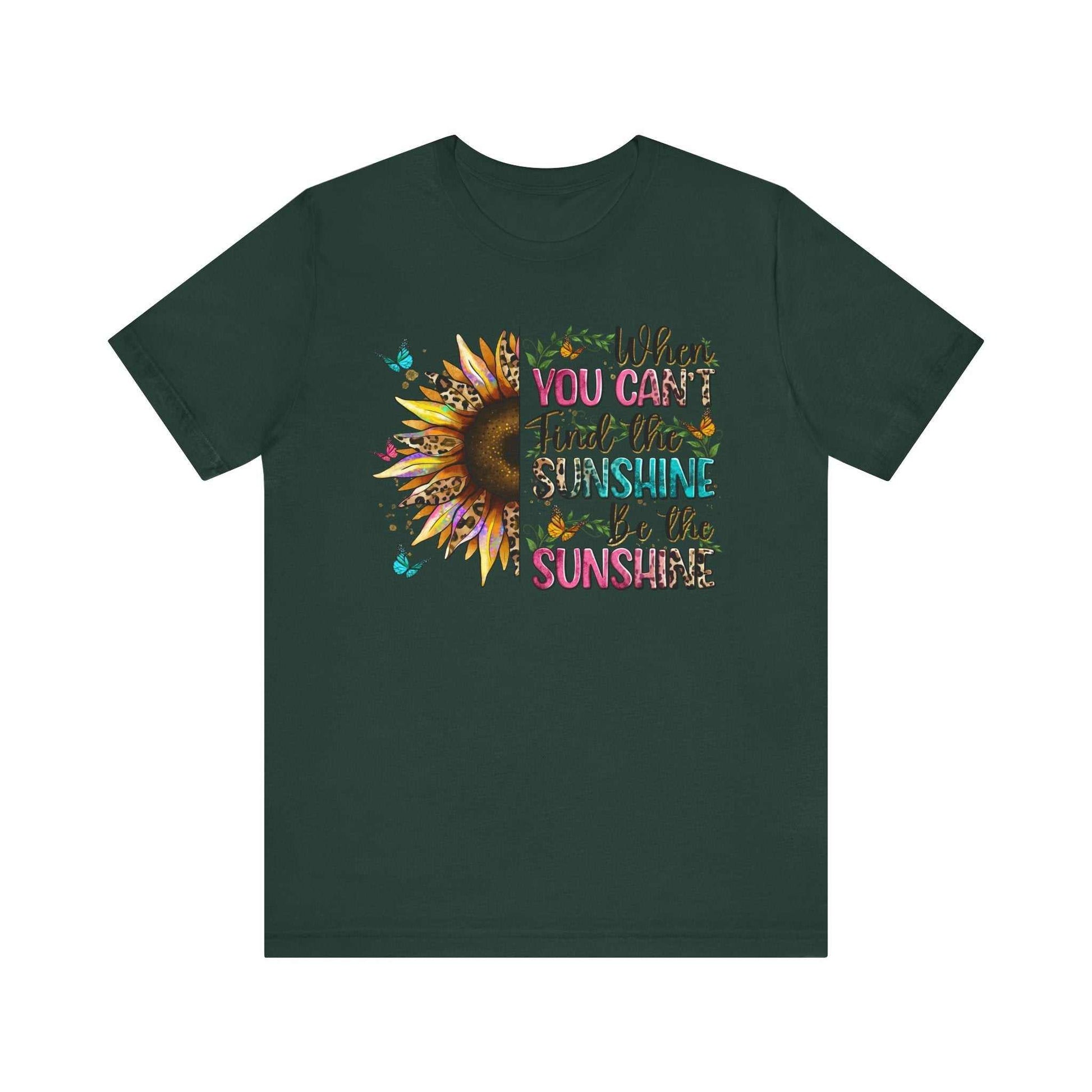 Dark green unisex t-shirt with colorful sunflower and inspirational "If you can't find the sunshine, be the sunshine" quote design.