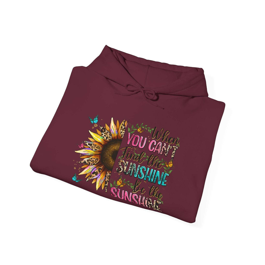 Folded maroon sunflower quote hoodie with colorful inspirational text and design