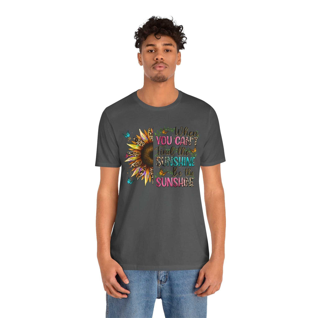 Man wearing charcoal grey Sunshine Quote Tee with colorful sunflower graphic and motivational text design