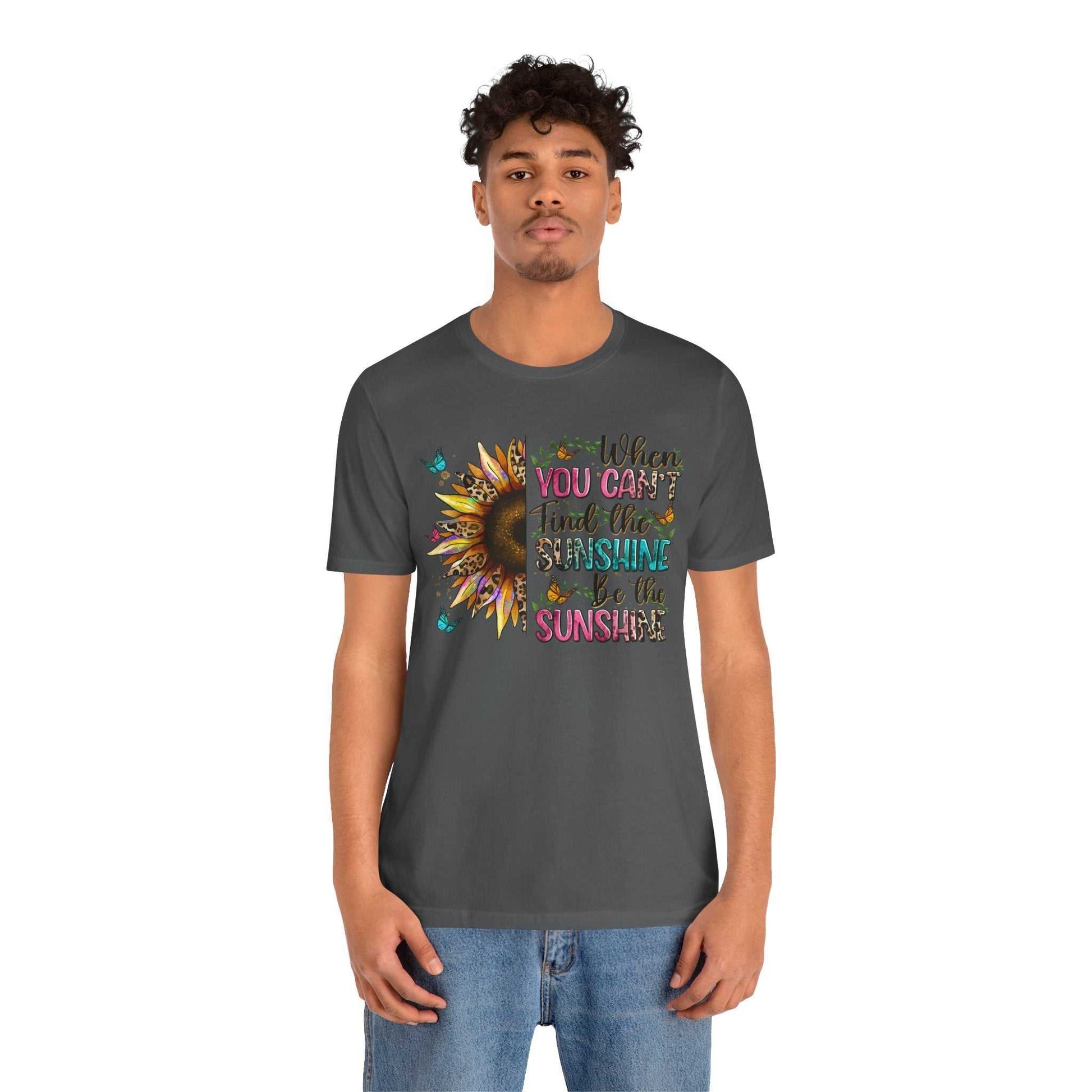 Man wearing charcoal grey Sunshine Quote Tee with colorful sunflower graphic and motivational text design