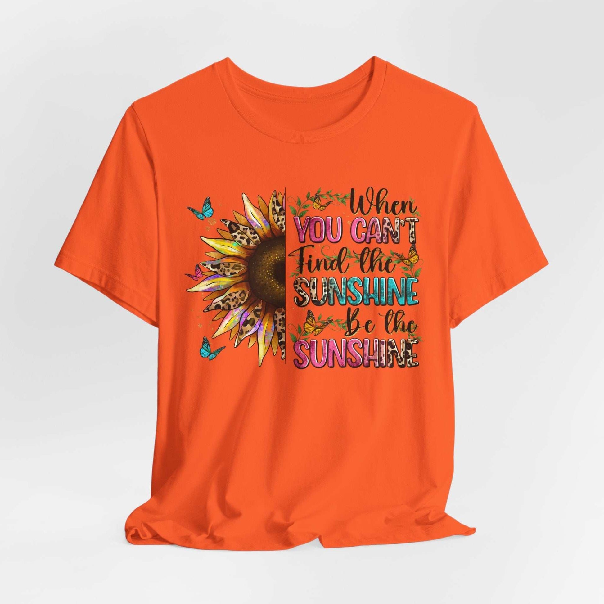 Orange unisex t-shirt with colorful sunflower and motivational sunshine quote design
