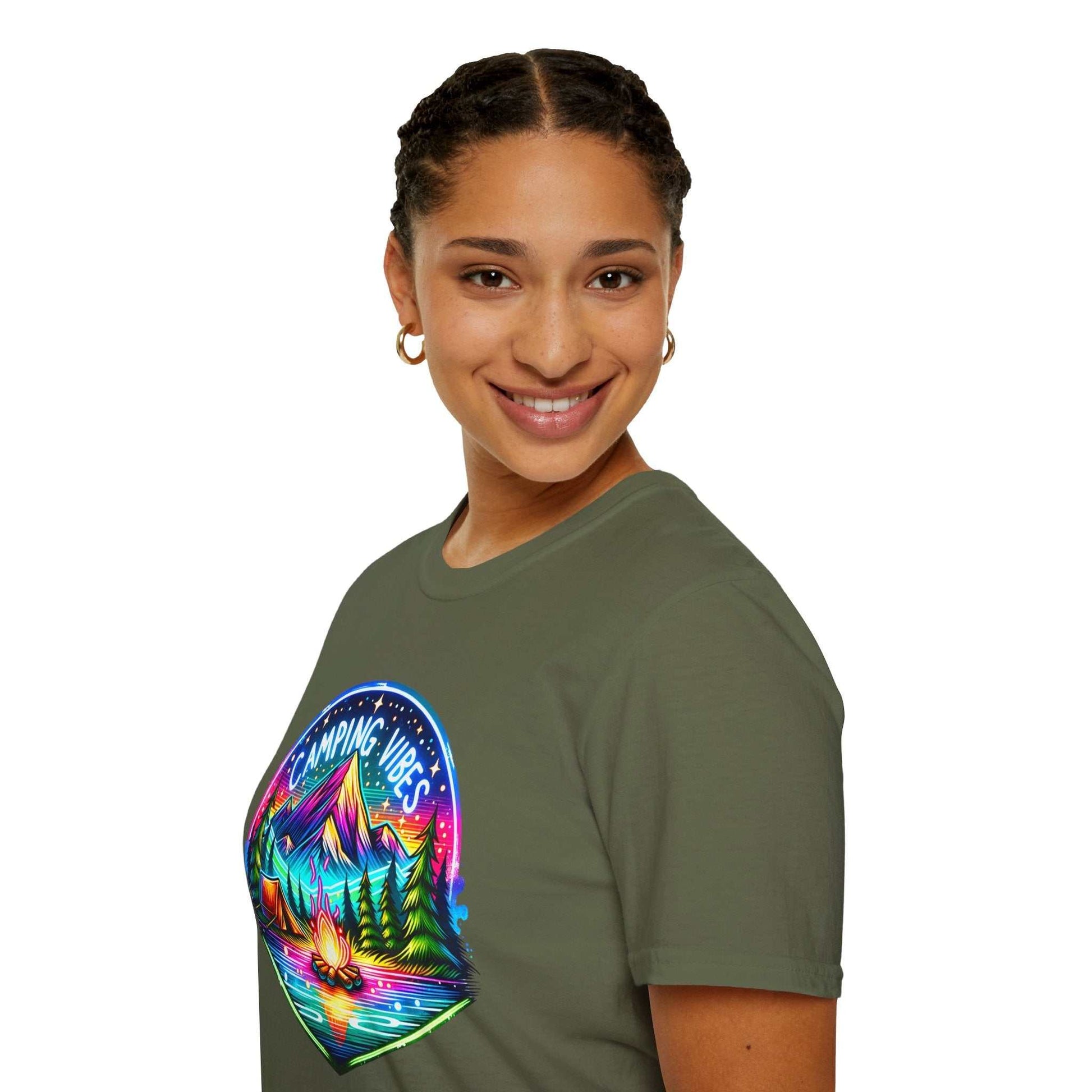 Unisex softstyle t-shirt with vibrant camping vibes graphic featuring mountains, trees, and campfire on olive green fabric