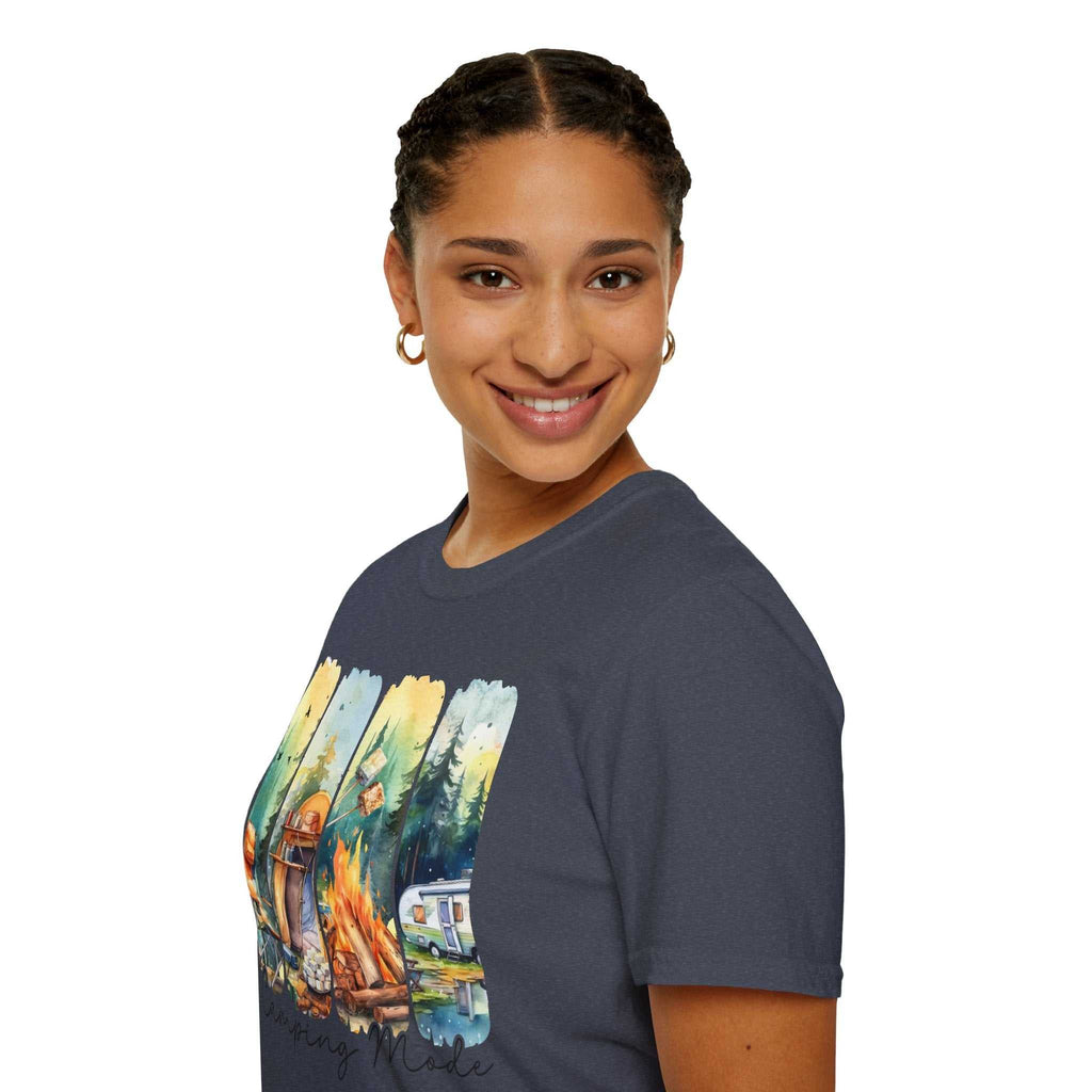 Woman wearing a dark Camping Adventure Unisex T-Shirt with a colorful outdoor campfire and camper design, smiling and posing against a white background.