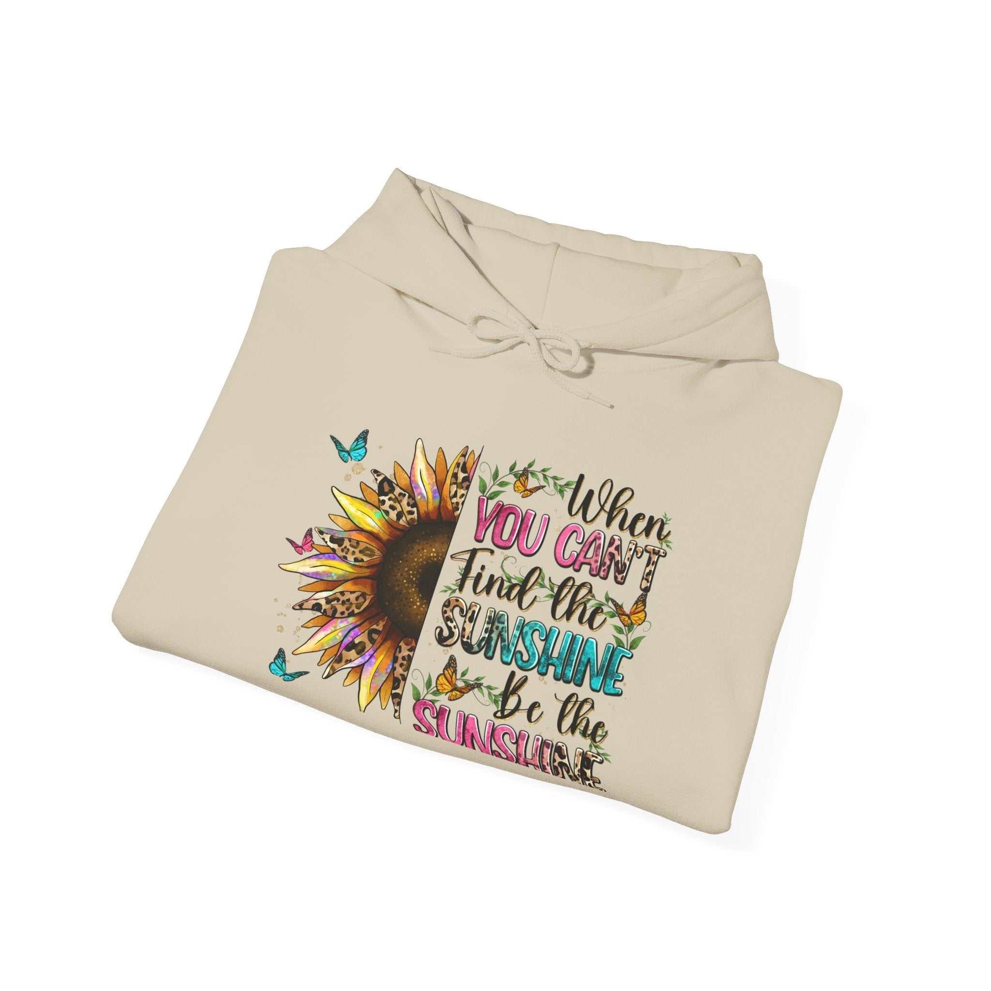 Folded beige sunflower quote hoodie with colorful inspirational text and butterfly design