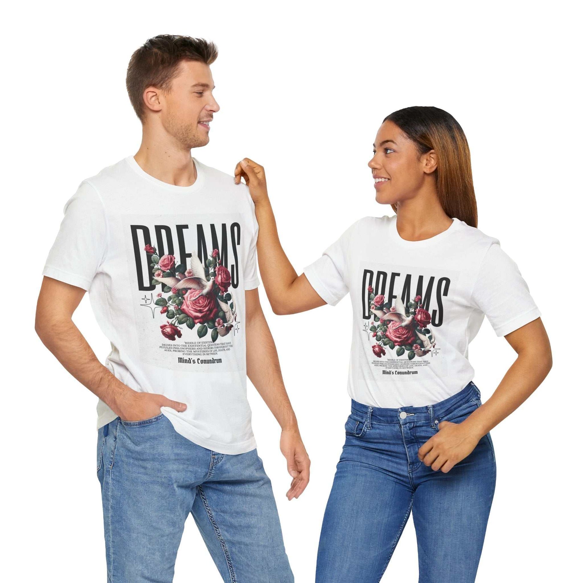 Couple wearing white Dreams Floral Tee with bold typography and pink floral design, styled casually with jeans.